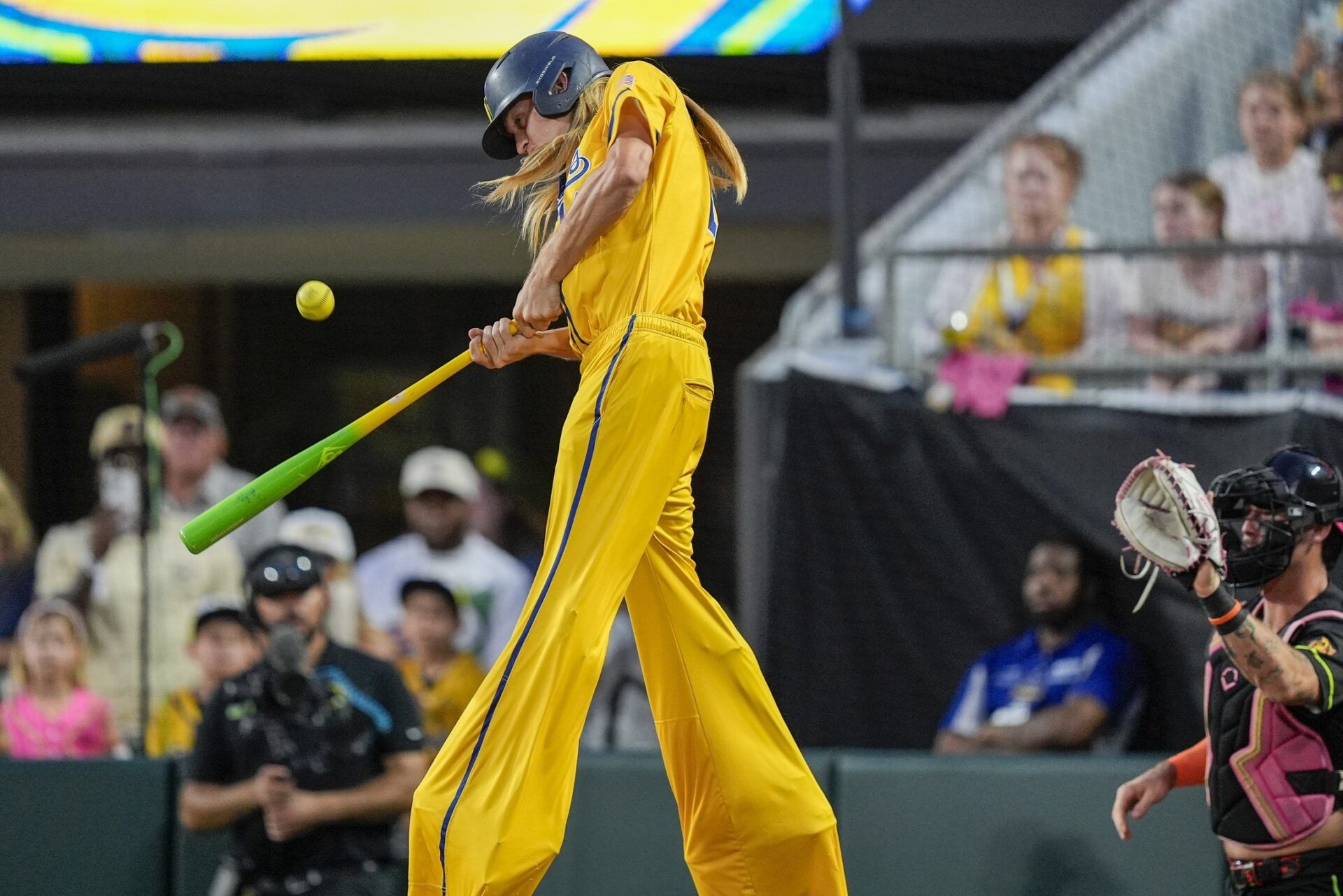 Savannah Bananas utility Dakota Albritton (14) hits on stilts against the Party Animals during the exhibition game at Bank of America Stadium.