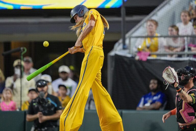 Savannah Bananas utility Dakota Albritton (14) hits on stilts against the Party Animals during the exhibition game at Bank of America Stadium.