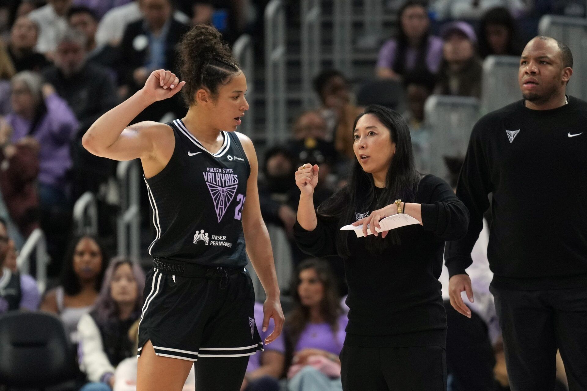Golden State Valkyries guard Veronica Burton (left) talks with head coach Natalie Nakase (center right) during the second quarter against the Las Vegas Aces at Chase Center.