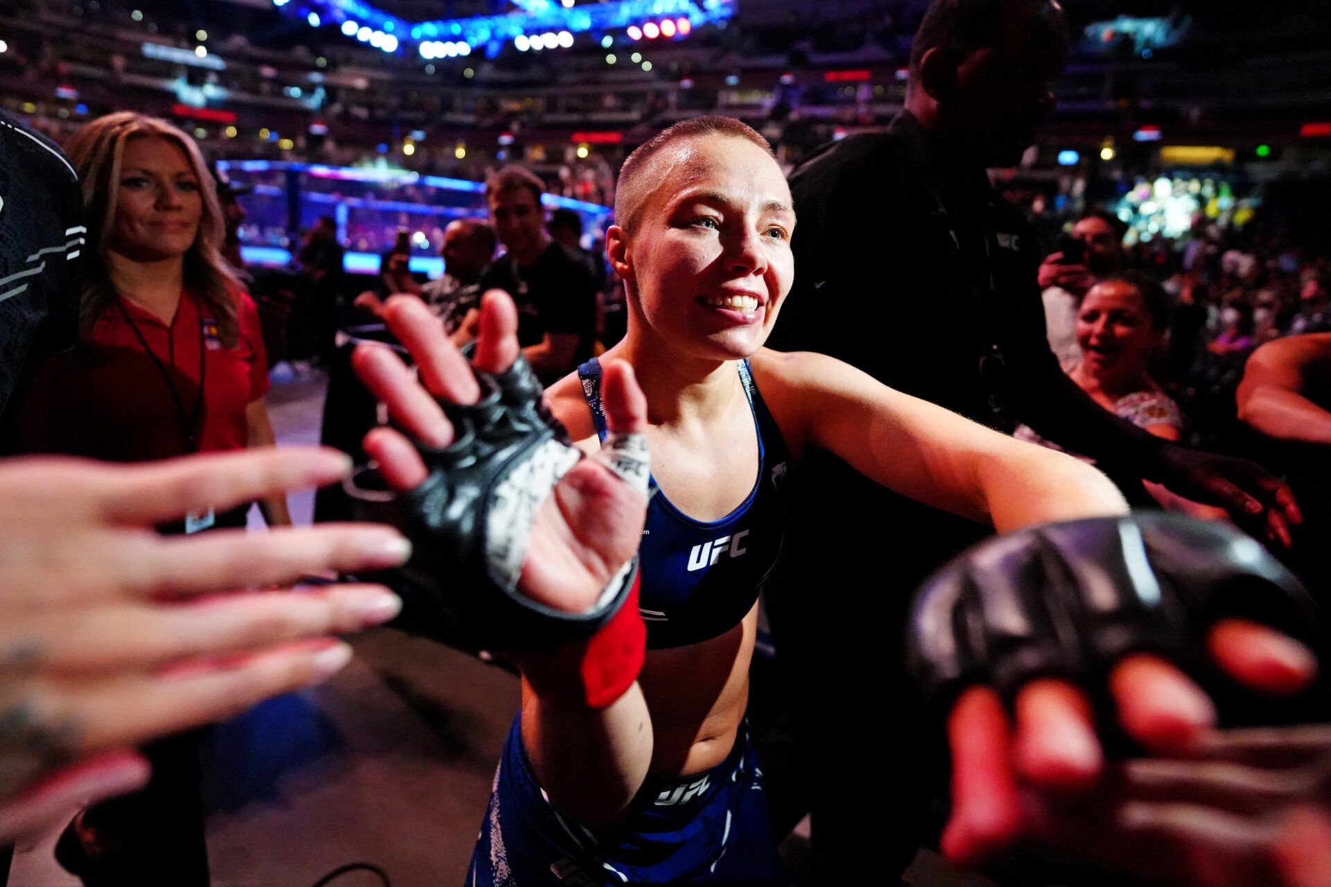 Rose Namajunas (red gloves) celebrates with fans after defeating Tracy Cortez (blue gloves) during UFC Fight Night at Ball Arena.