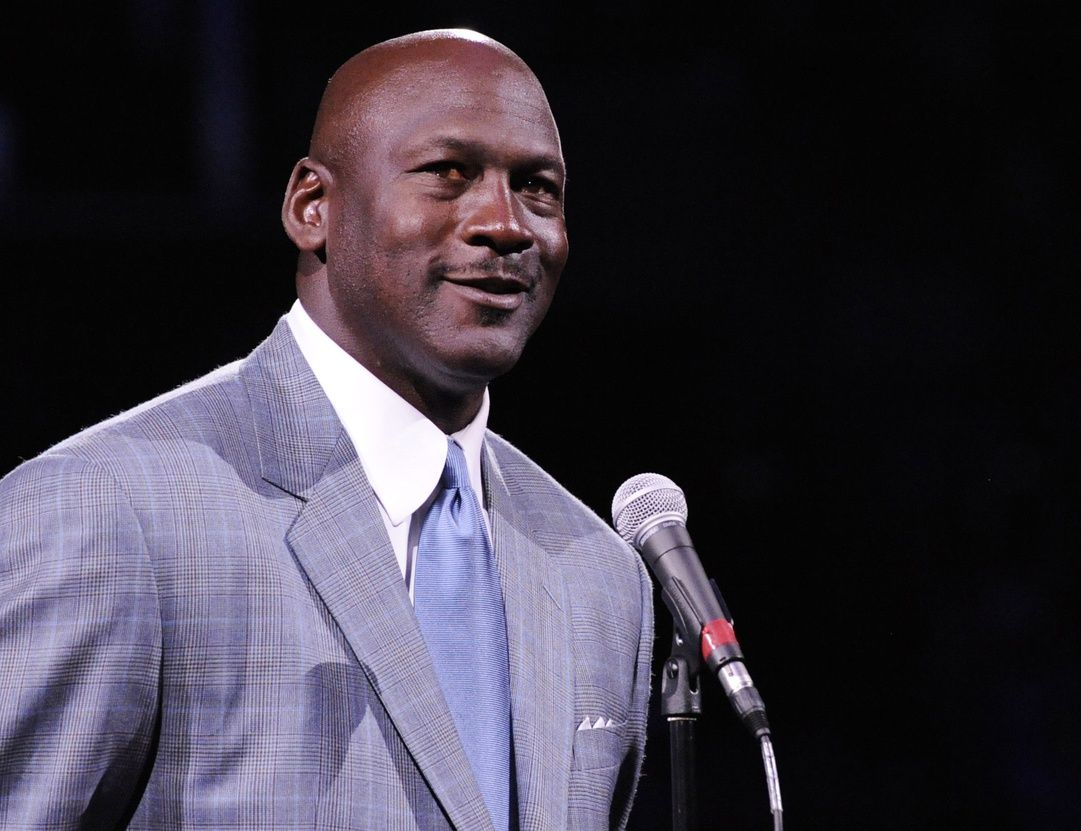 Charlotte Bobcats owner Michael Jordan unveils the new Charlotte Hornets logo at halftime during the game against the Utah Jazz at Time Warner Cable Arena.
