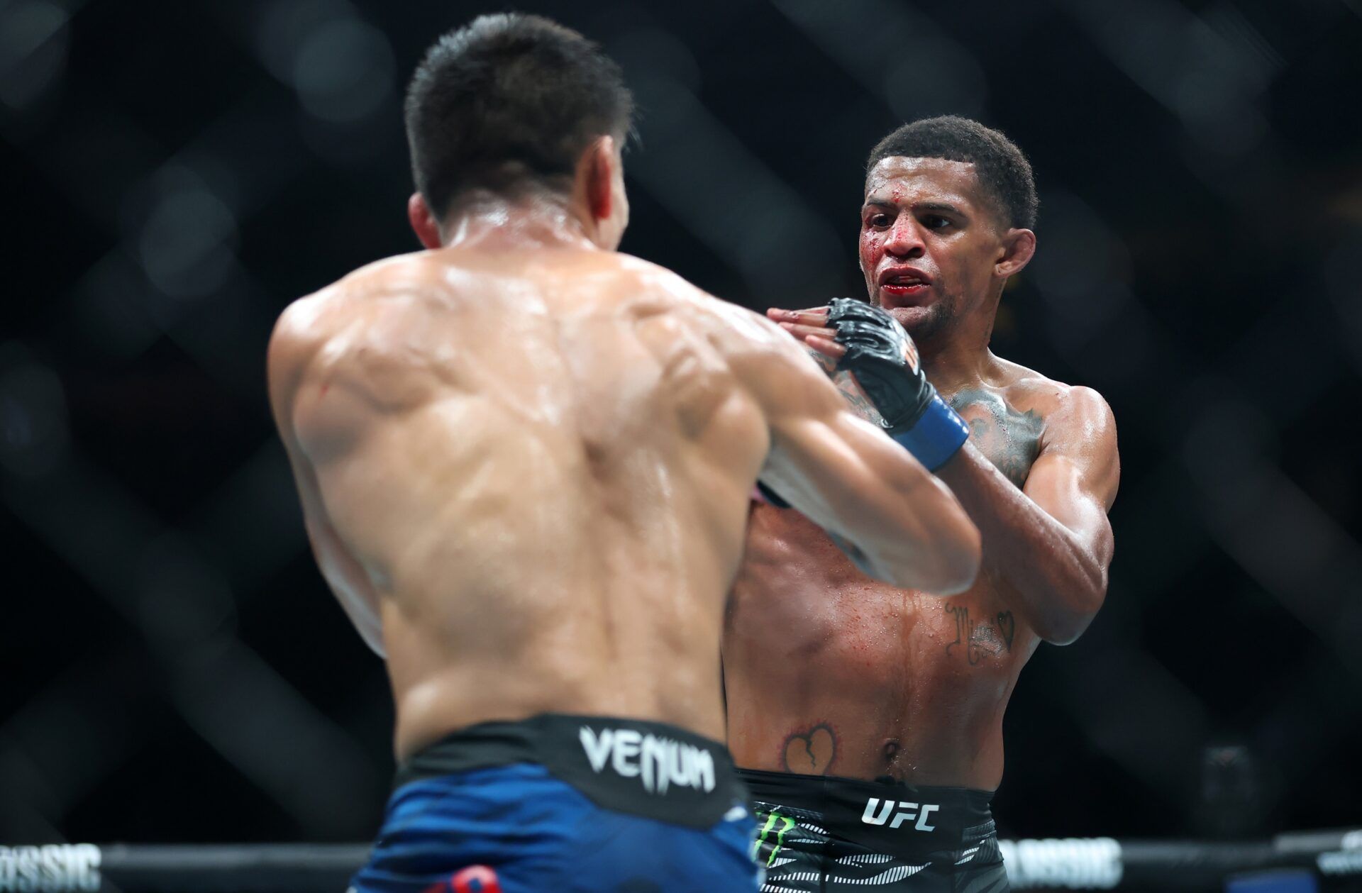 Mario Bautista (red gloves) fights Patchy Mix (blue gloves) during UFC 316 at Prudential Center.