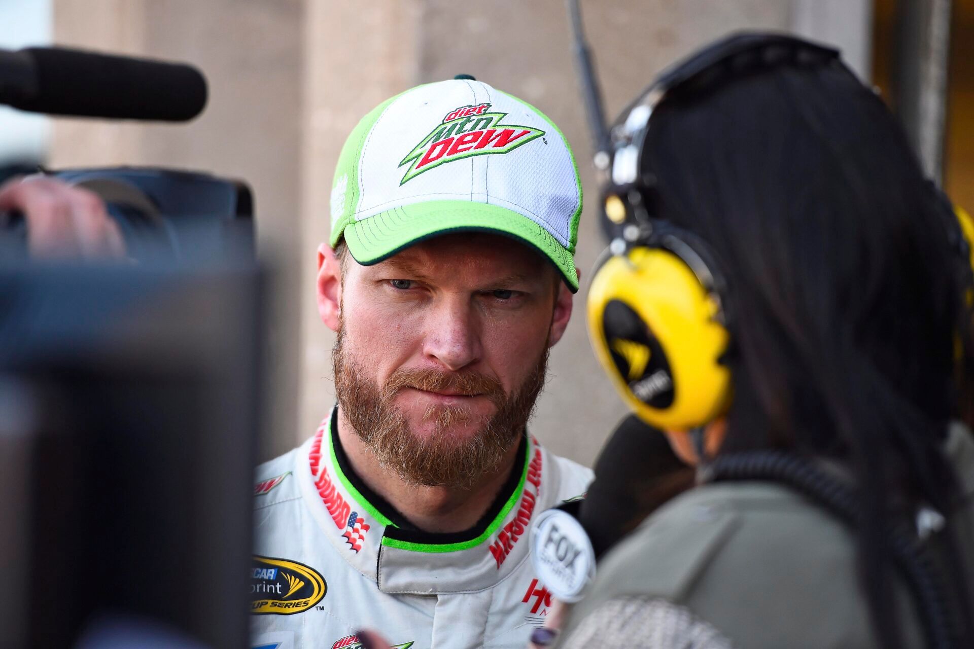 NASCAR Sprint Cup Series driver Dale Earnhardt Jr. (88) gives an interview for the television broadcast during practice for the AAA Texas 500 at Texas Motor Speedway.