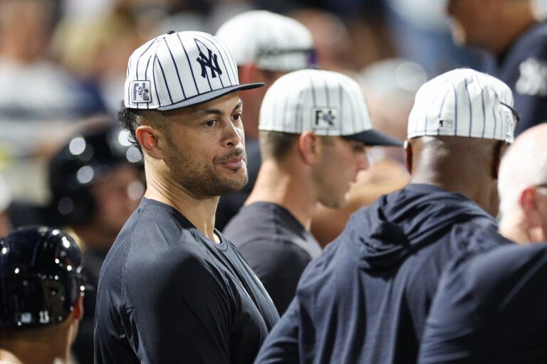 New York Yankees designated hitter Giancarlo Stanton (27) looks on from the dugout against the Philadelphia Phillies in the sixth inning during spring training at George M. Steinbrenner Field.