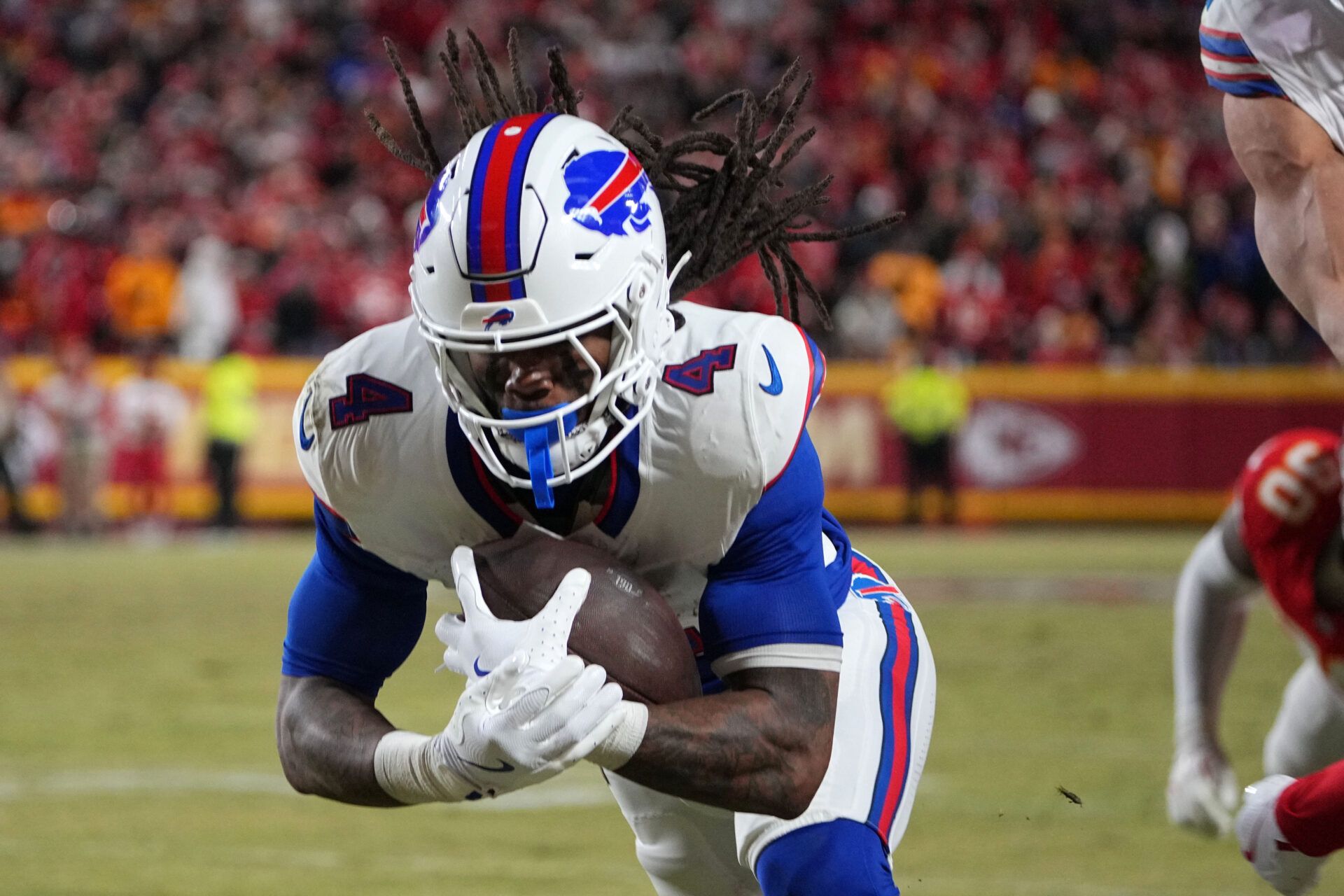 Buffalo Bills running back James Cook (4) dives for a touchdown against the Kansas City Chiefs in the AFC Championship game at GEHA Field at Arrowhead Stadium.