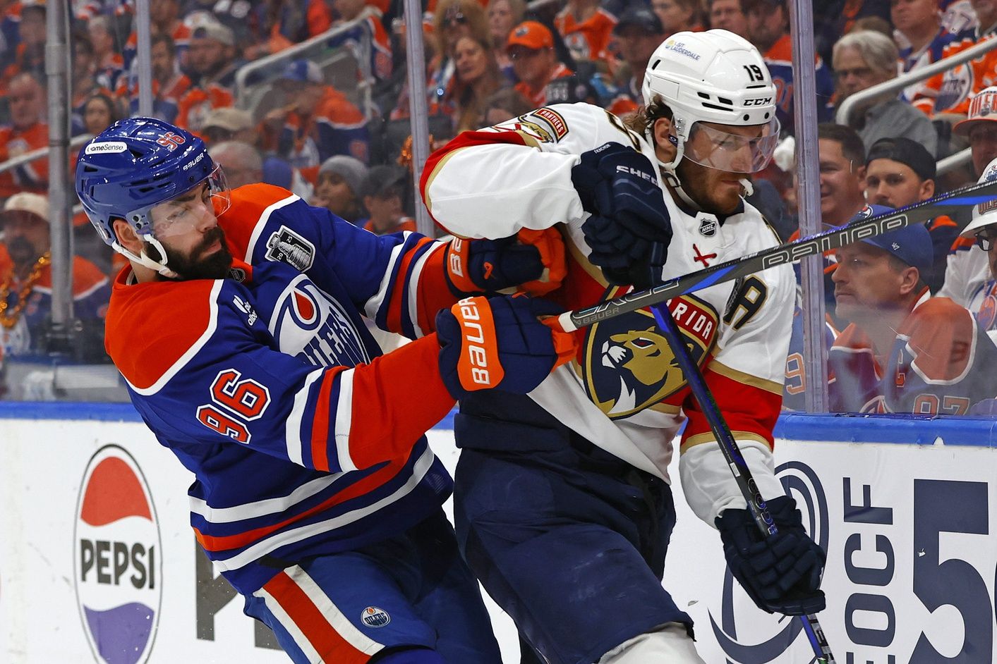 Edmonton Oilers defenseman Jake Walman (96) checks Florida Panthers left wing Matthew Tkachuk (19) during the second period in game two of the 2025 Stanley Cup Final at Rogers Place.