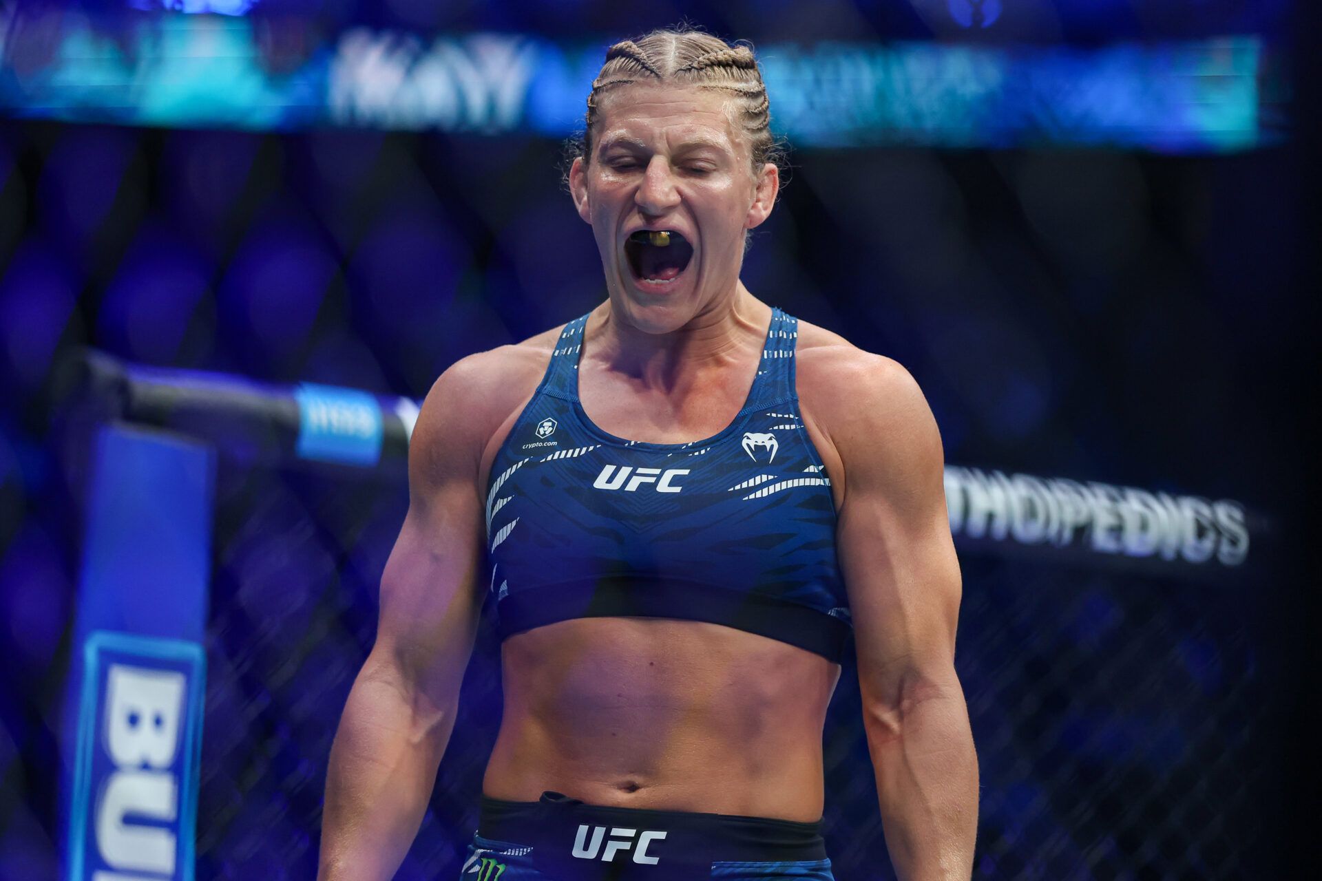 Kayla Harrison (blue gloves) prepares to fight Julianna Pena (not pictured) in a bantamweight title bout during UFC 316 at Prudential Center.