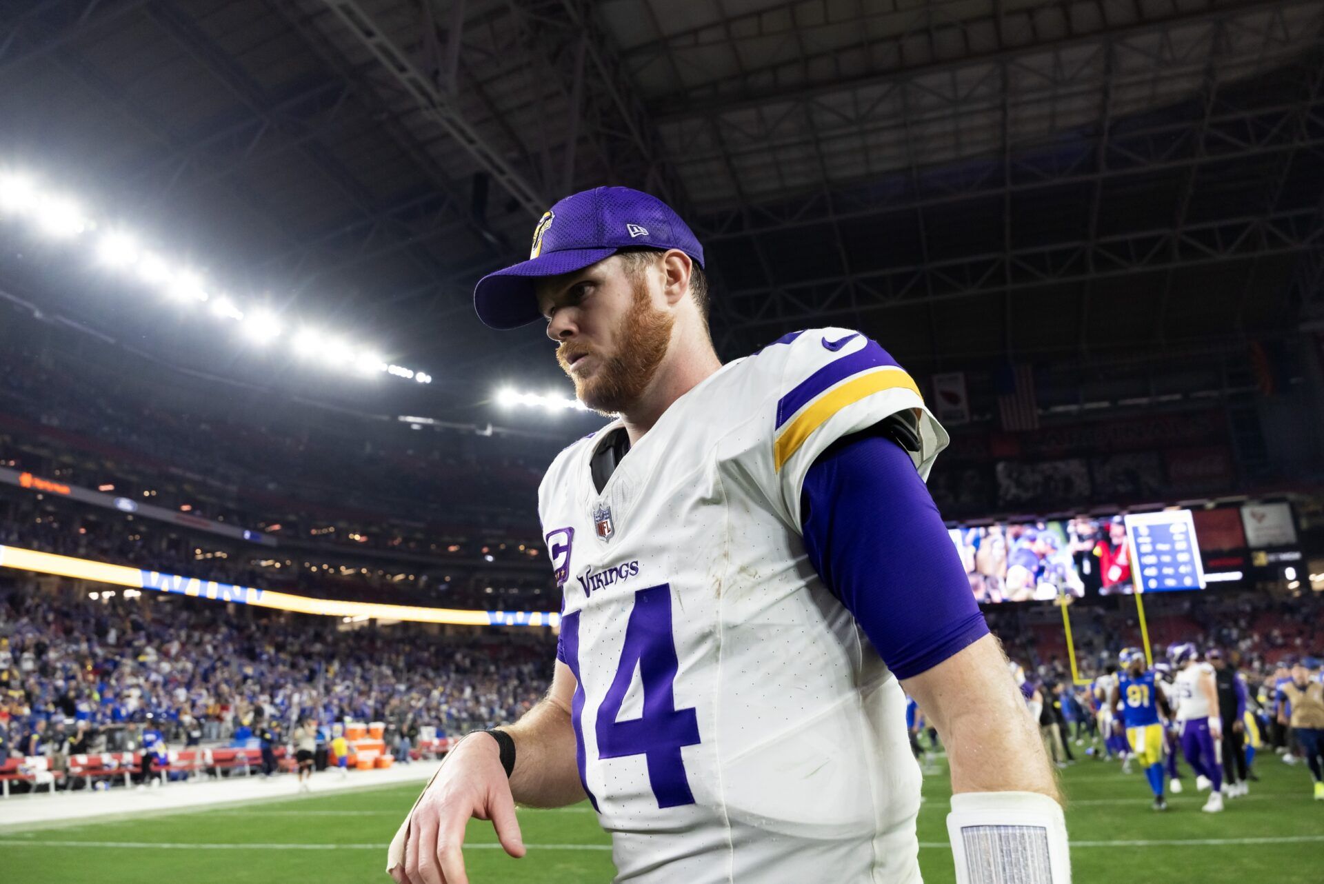 Minnesota Vikings quarterback Sam Darnold (14) reacts as he walks off the field after losing to the Los Angeles Rams during an NFC wild card game at State Farm Stadium.