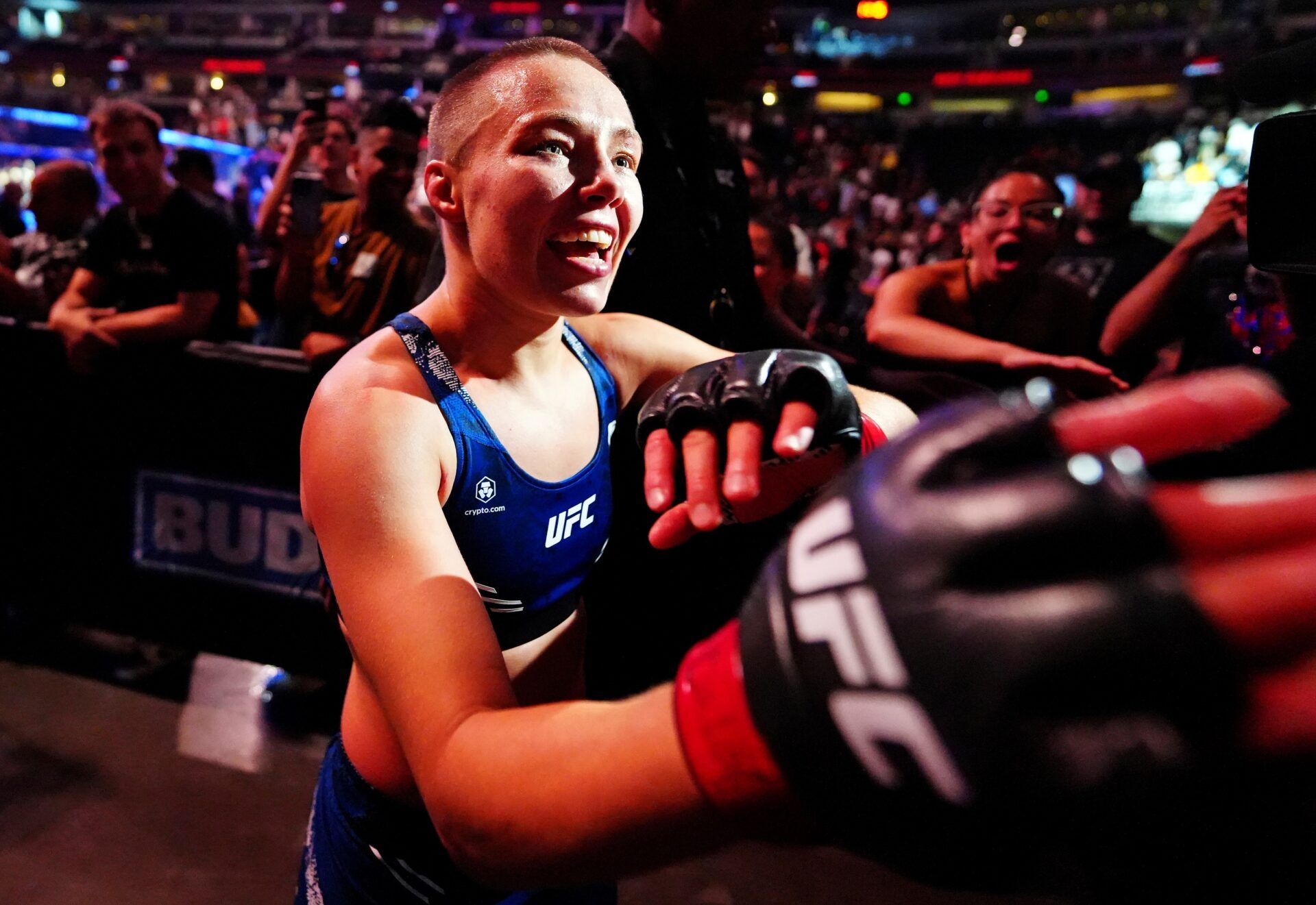 Rose Namajunas (red gloves) celebrates with fans after defeating Tracy Cortez (blue gloves) during UFC Fight Night at Ball Arena.
