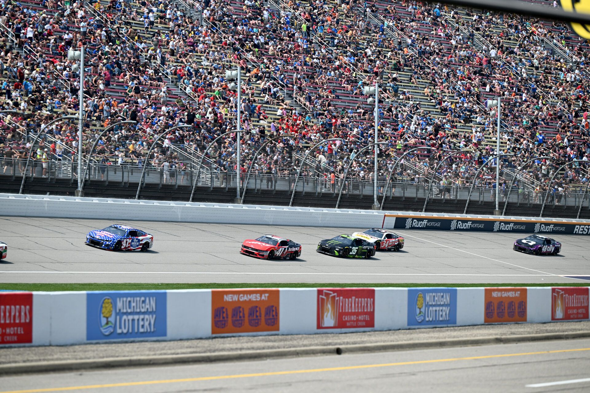The field races down the main straightaway in stage one of the FireKeepers Casino 400 at Michigan International Speedway.