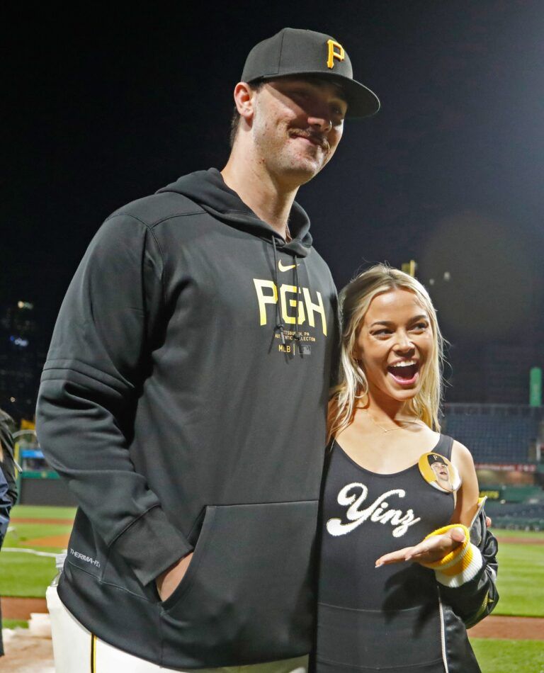 Pittsburgh Pirates starting pitcher Paul Skenes (30) poses with his girlfriend Louisiana State University gymnast Olivia Dunne (right) after Skenes made his major league debut against the Chicago Cubs at PNC Park.