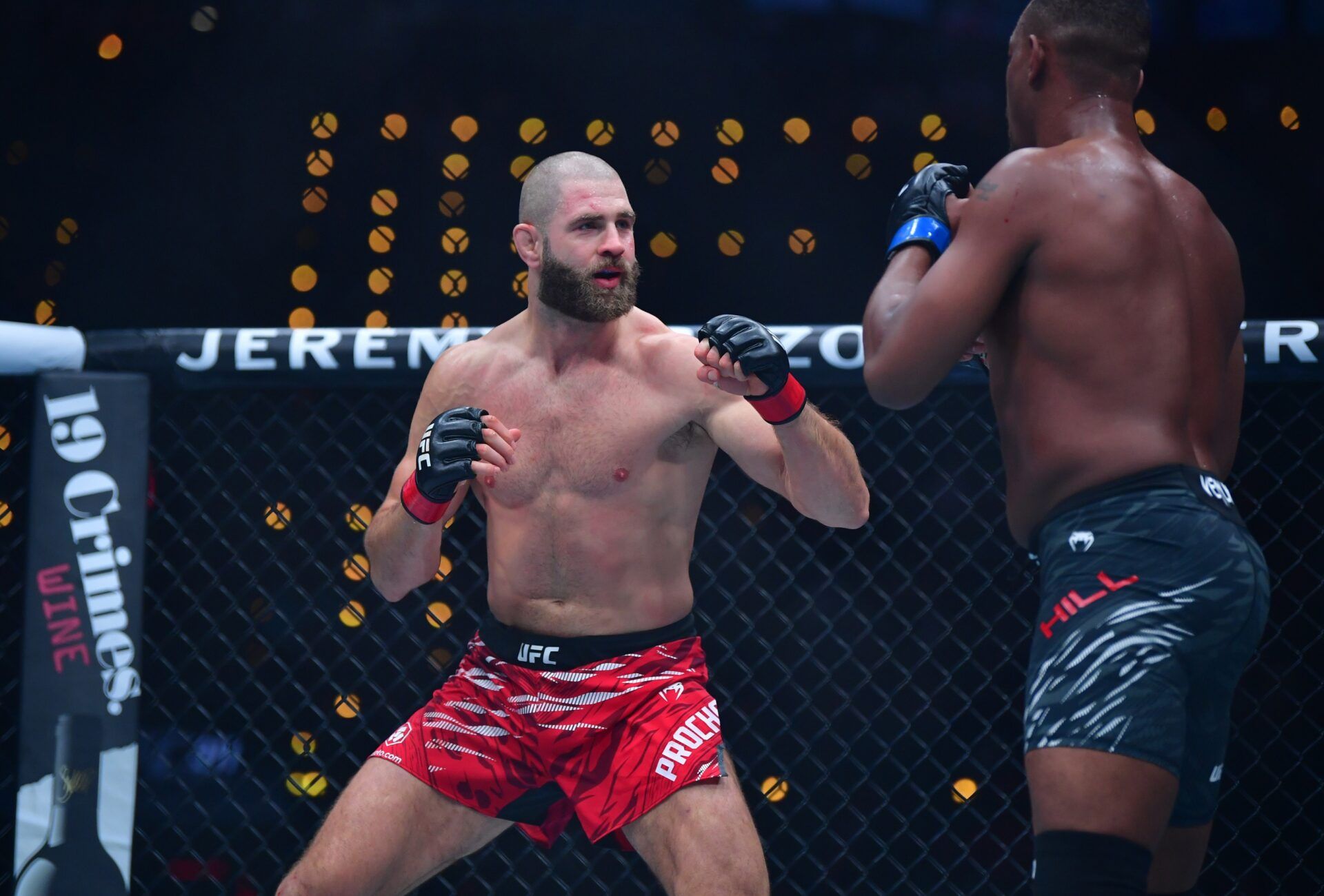 Jiri Prochazka (red gloves) fights Jamahal Hill (blue gloves) during UFC 311 at Intuit Dome.