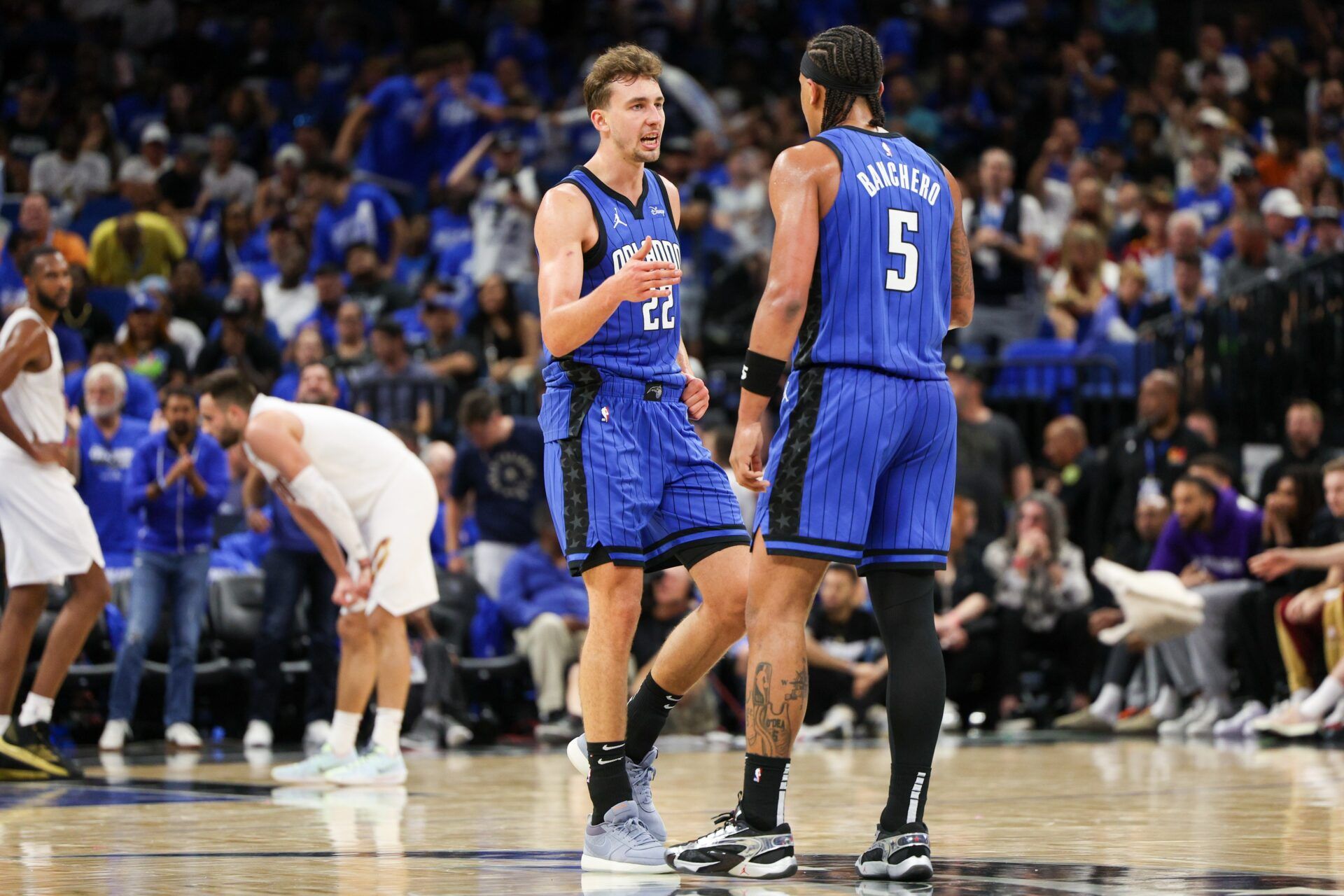 Orlando Magic forward Franz Wagner (22) and forward Paolo Banchero (5) celebrate after a basket against the Cleveland Cavaliers in the third quarter during game four of the first round for the 2024 NBA playoffs at Kia Center.