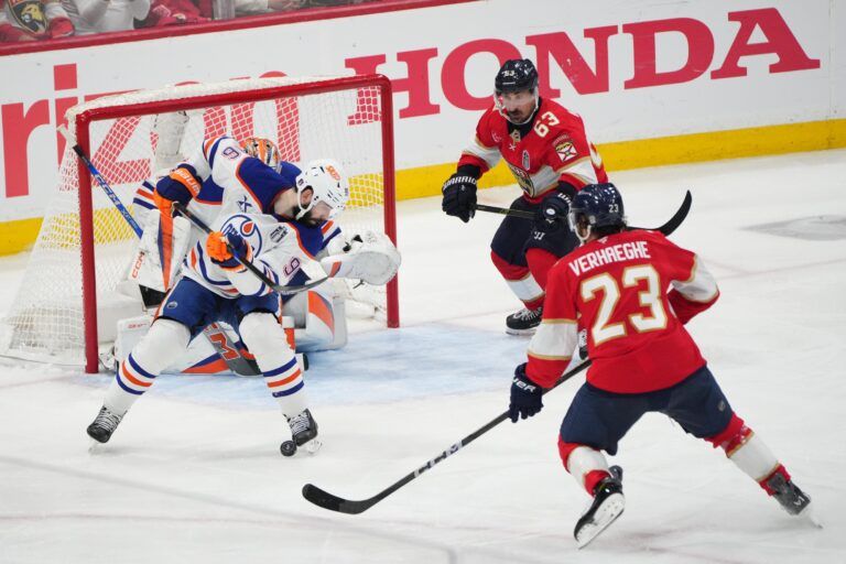 Edmonton Oilers defenseman Jake Walman (96) defends against Florida Panthers forward Carter Verhaeghe (23) during the third period in game three of the 2025 Stanley Cup Final at Amerant Bank Arena.