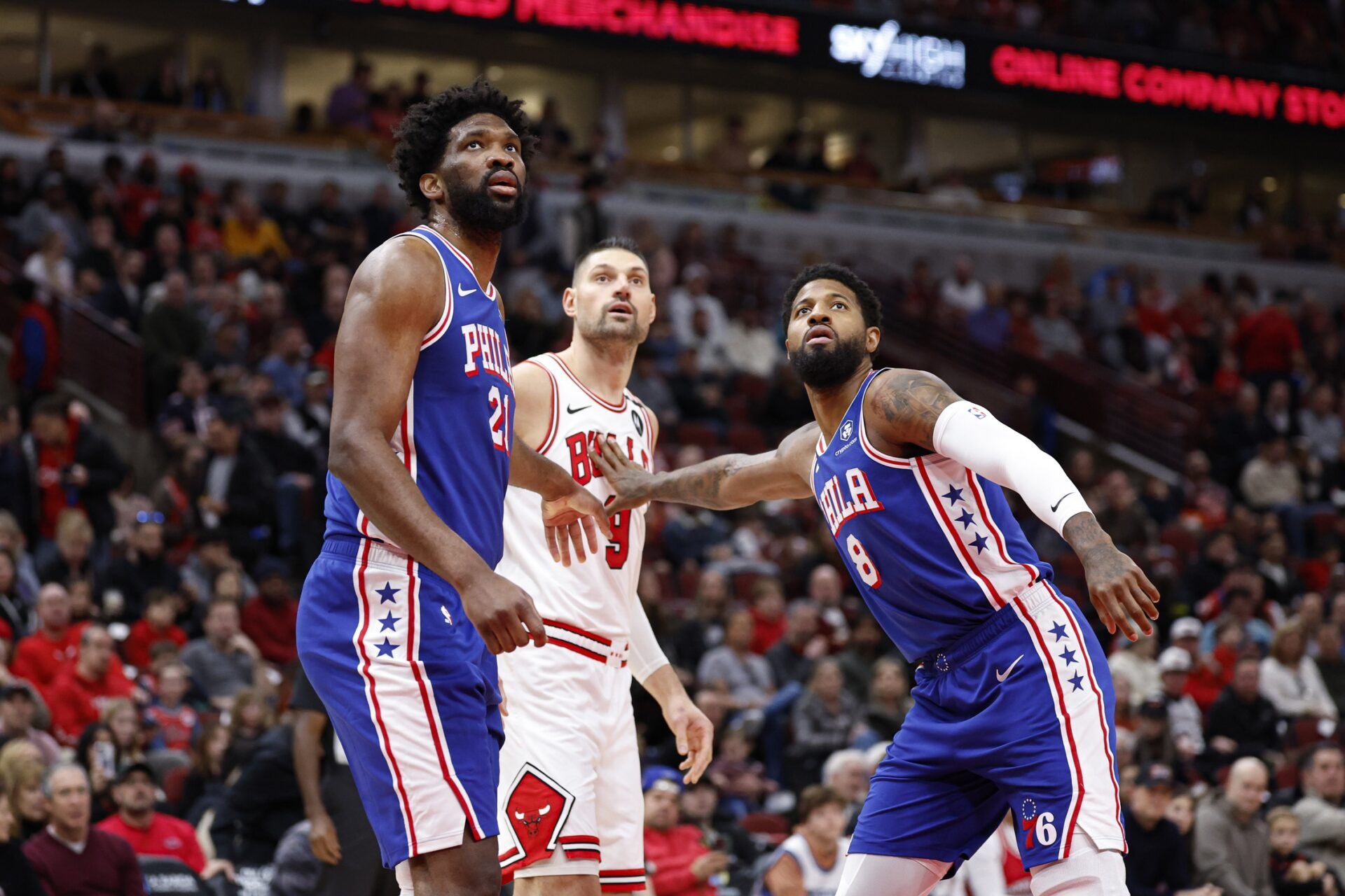 Philadelphia 76ers center Joel Embiid (21) and forward Paul George (8) defend against Chicago Bulls center Nikola Vucevic (9) during the first half at United Center.