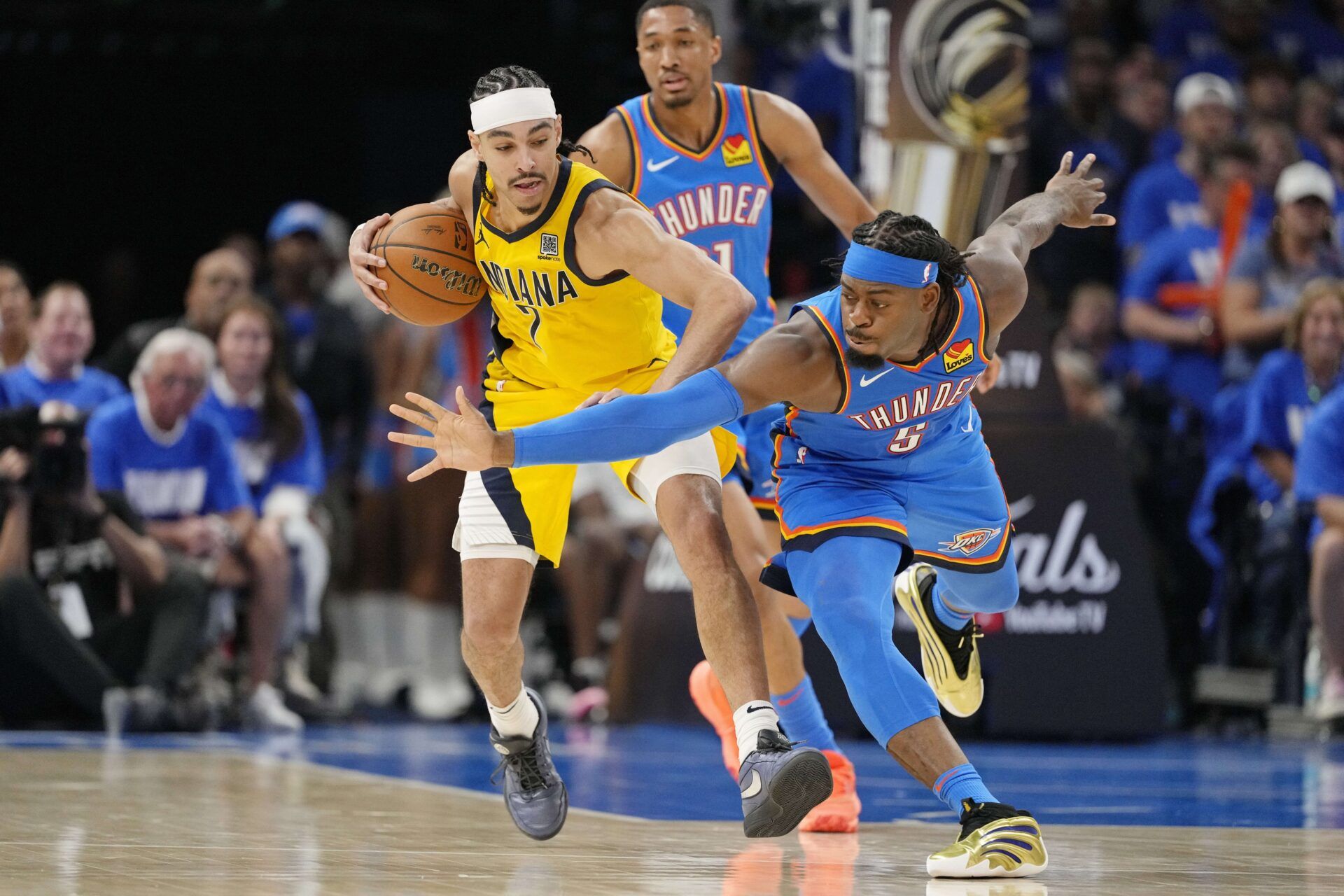 Oklahoma City Thunder guard Luguentz Dort (5) reaches for the ball against Indiana Pacers guard Andrew Nembhard (2) during the second half during game two of the 2025 NBA Finals at Paycom Center.