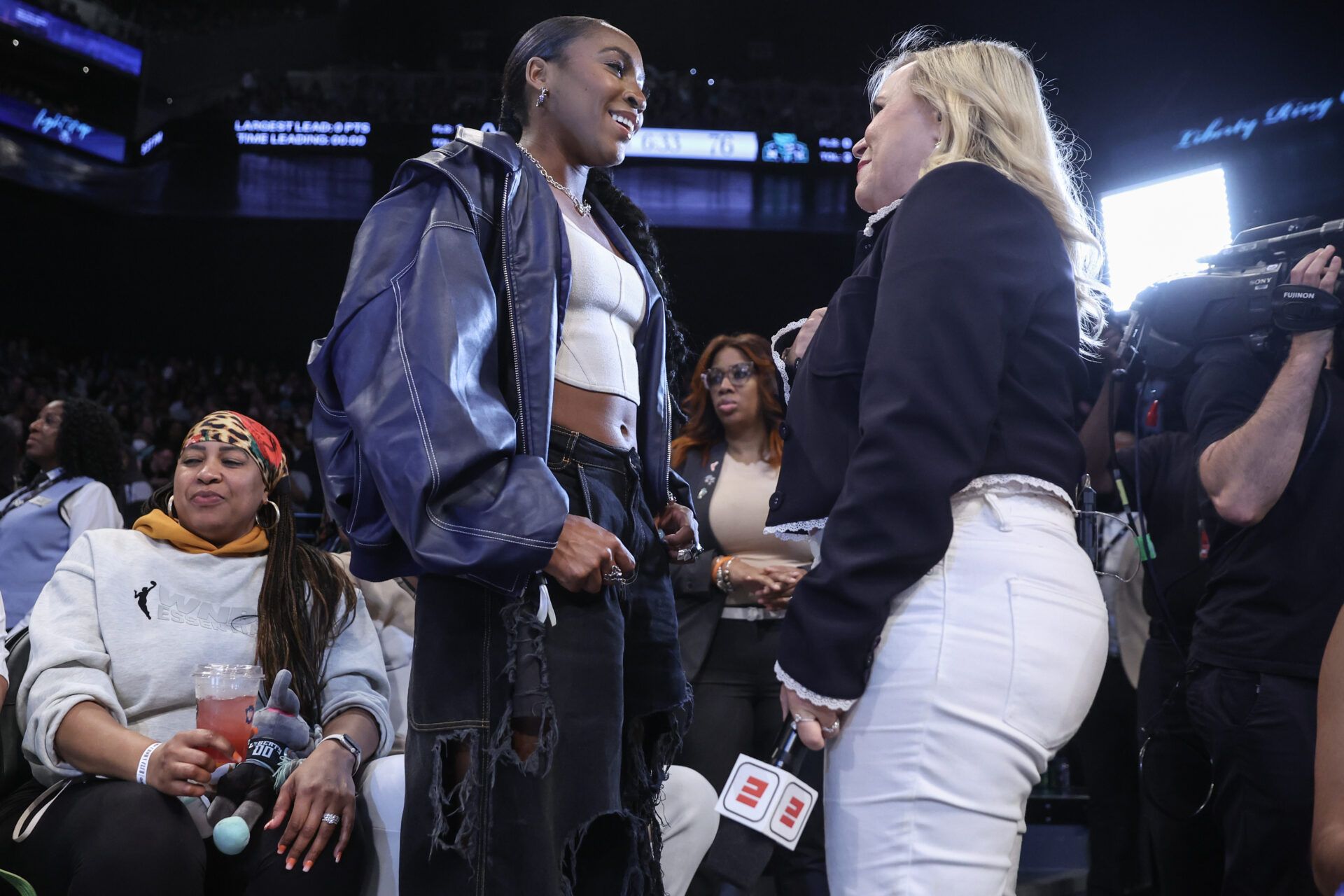 Professional tennis player Coco Gauff (l) talks with ESPN reporter Holly Rowe in the fourth quarter of the game between the Chicago Sky and the New York Liberty at Barclays Center.