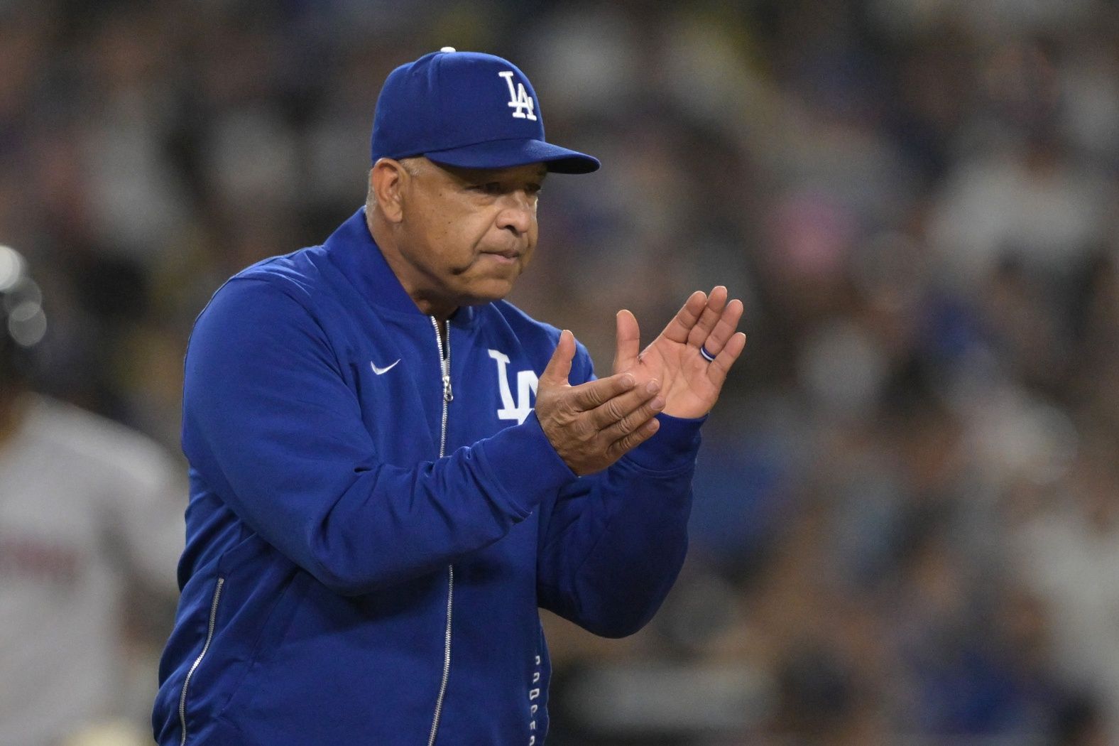 Los Angeles Dodgers manager Dave Roberts (30) walks to the mound for a pitching change in the eighth inning against the Arizona Diamondbacks at Dodger Stadium.