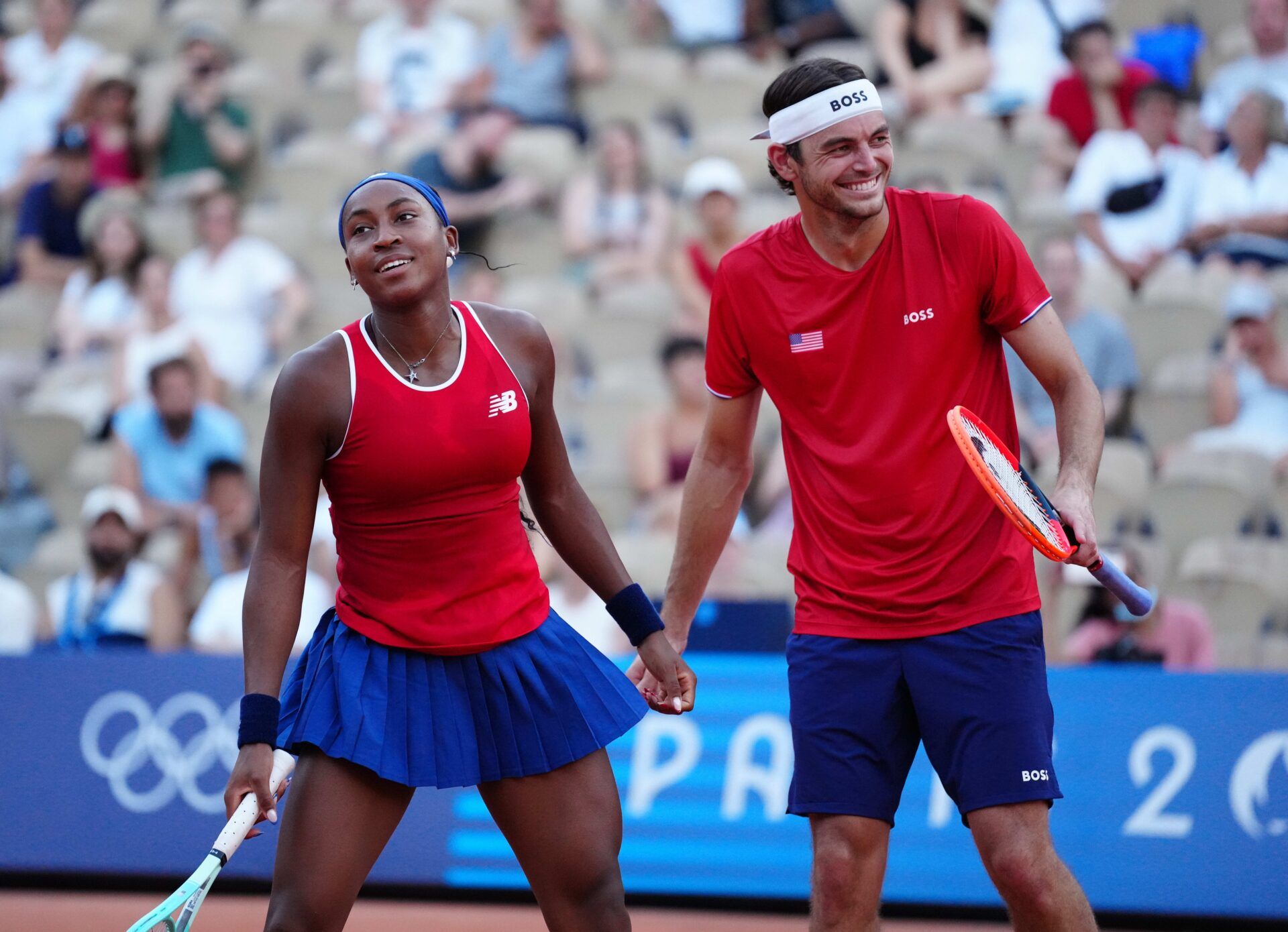 Coco Gauff (USA) and Taylor Fritz (USA) react during a mixed doubles tennis match during the Paris 2024 Olympic Summer Games at Stade Roland Garros.
