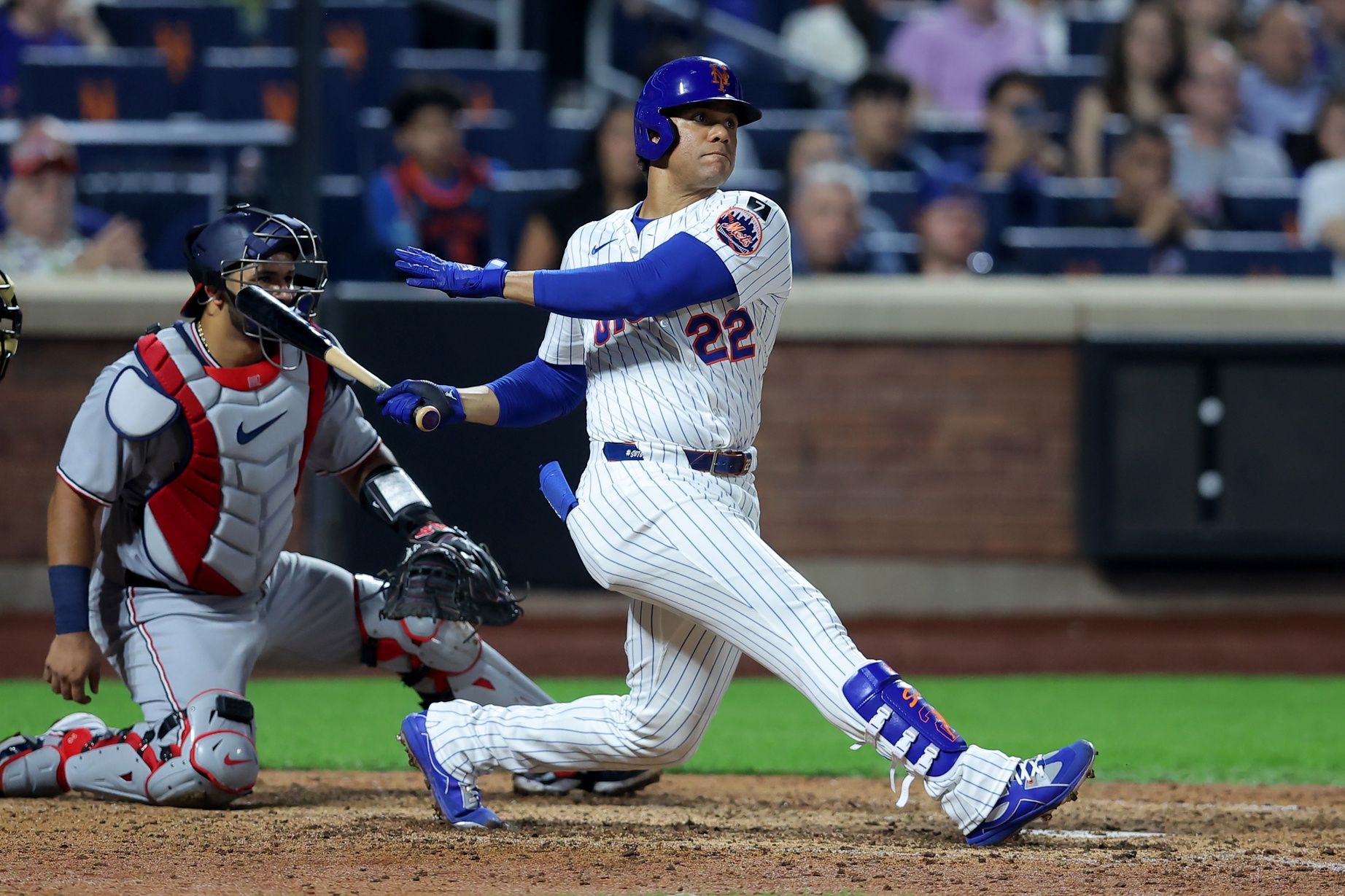 New York Mets right fielder Juan Soto (22) follows through on an RBI double against the Washington Nationals during the eighth inning at Citi Field.