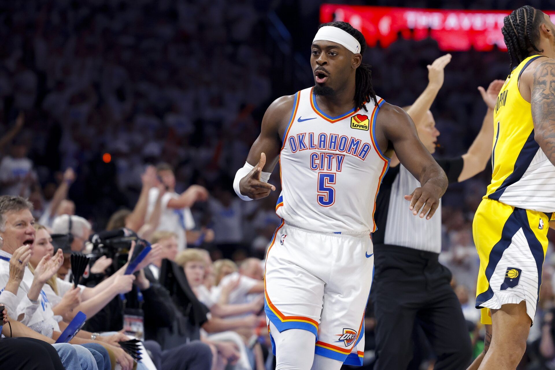Oklahoma City Thunder guard Luguentz Dort (5) celebrates making a three point basket as Indiana Pacers forward Obi Toppin (1) looks on during the third quarter during game one of the 2025 NBA Finals at Paycom Center.