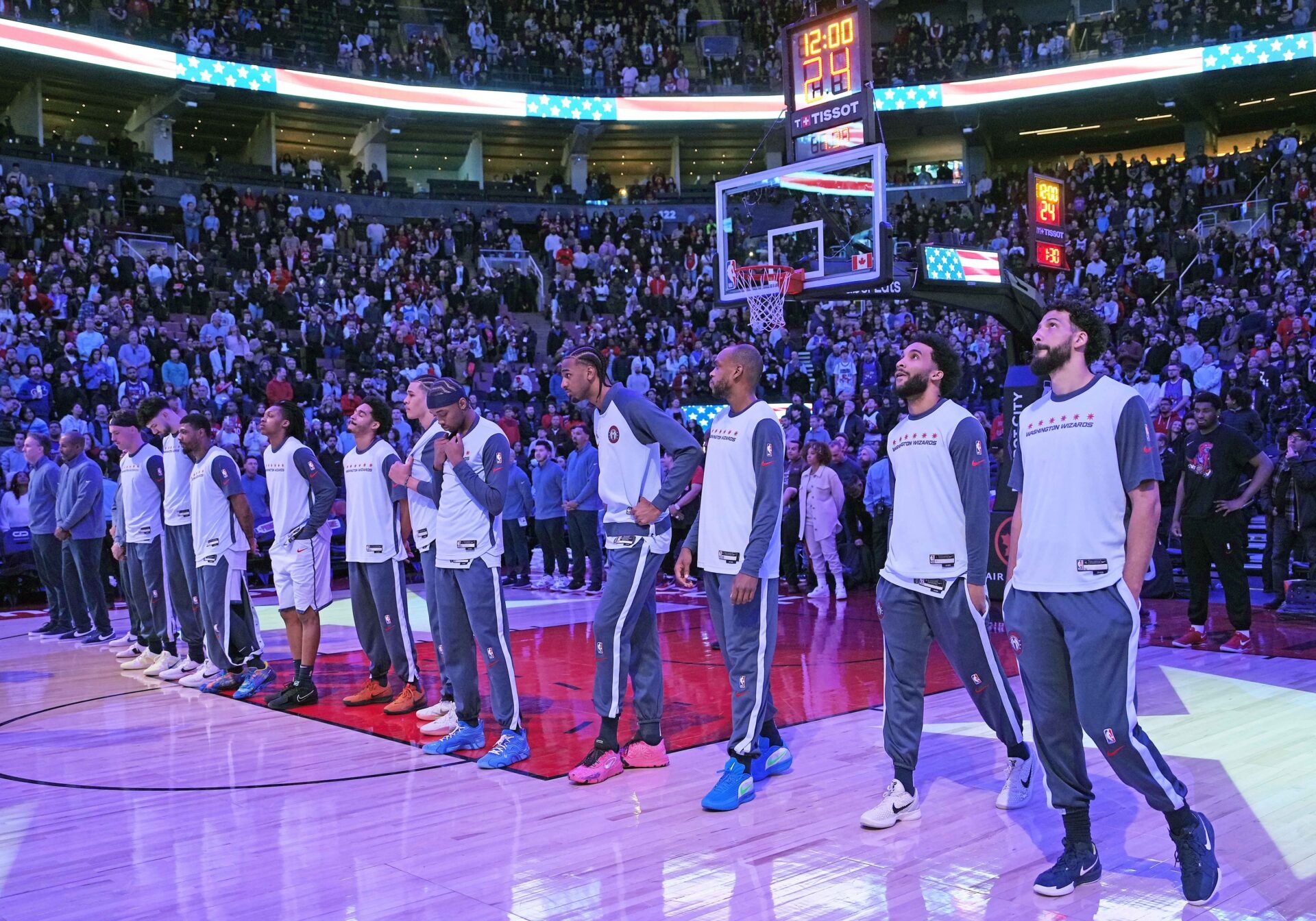 The Washington Wizards players stand during the United States national anthem before a game against the Toronto Raptors at Scotiabank Arena.