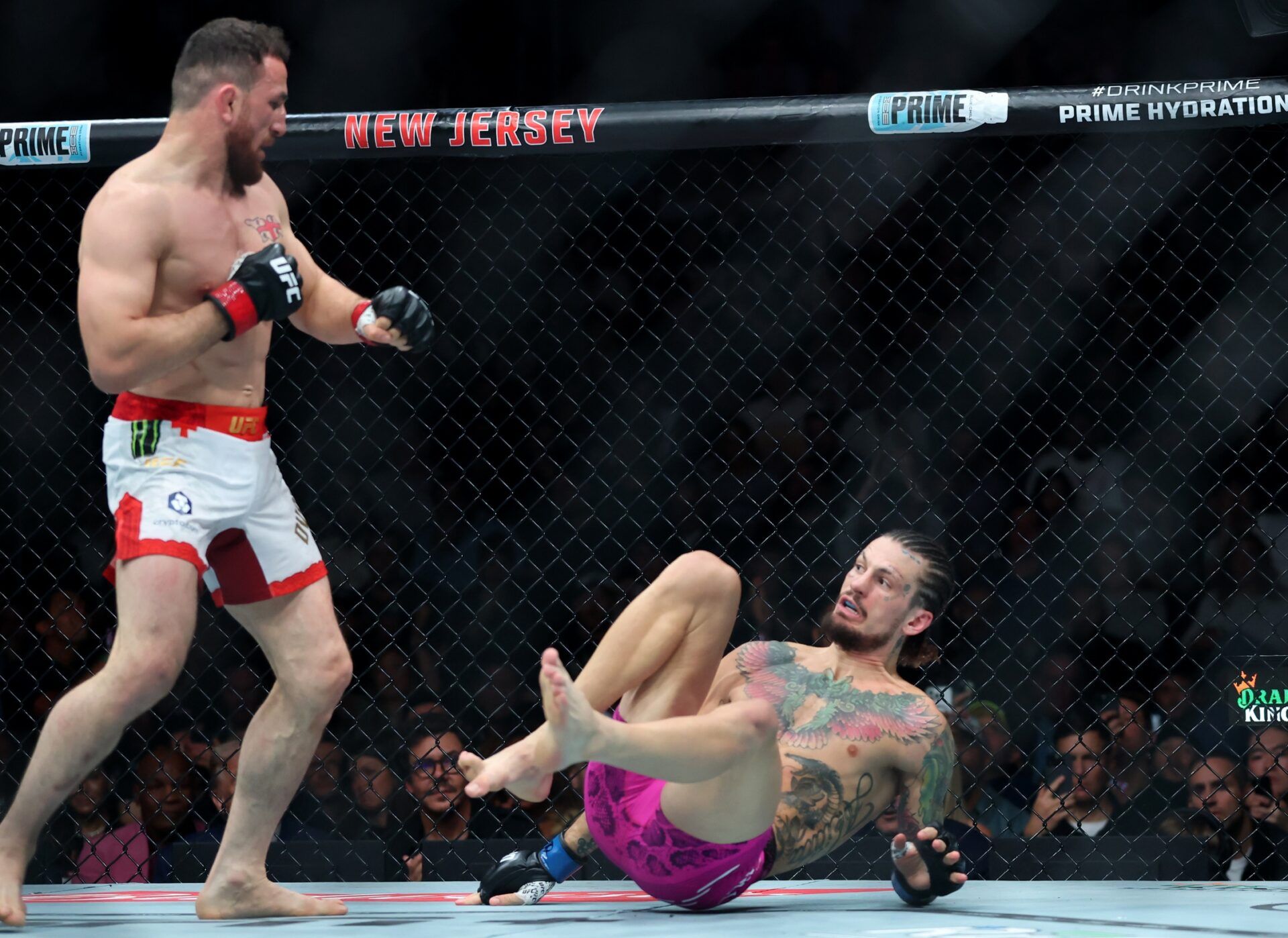 Merab Dvalishvili (red gloves) fights Sean O’Malley (blue gloves) in a bantamweight title fight during UFC 316 at Prudential Center.