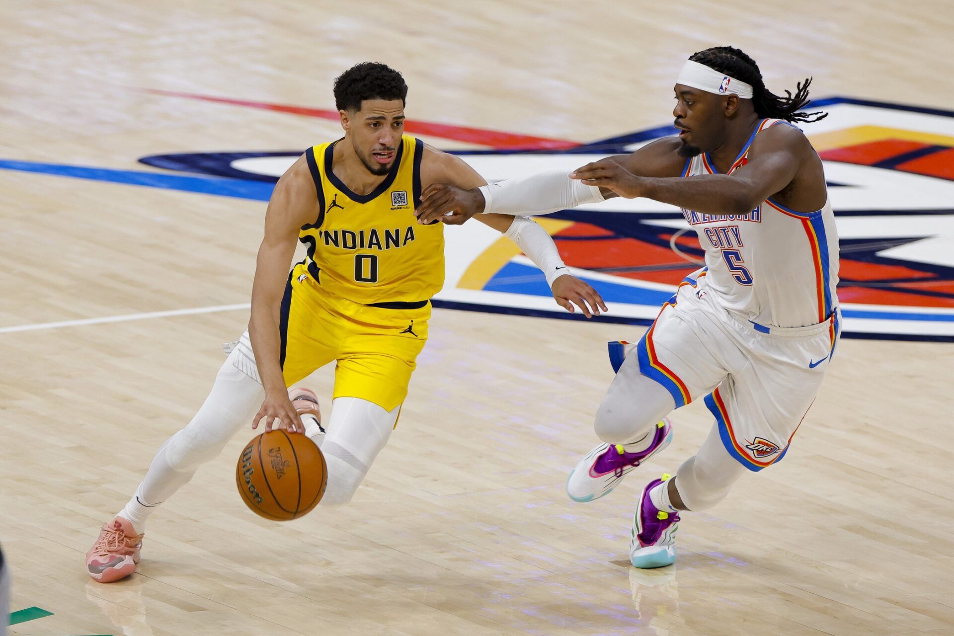 Indiana Pacers guard Tyrese Haliburton (0) drives to the basket past Oklahoma City Thunder guard Luguentz Dort (5) during the second quarter during game one of the 2025 NBA Finals at Paycom Center.