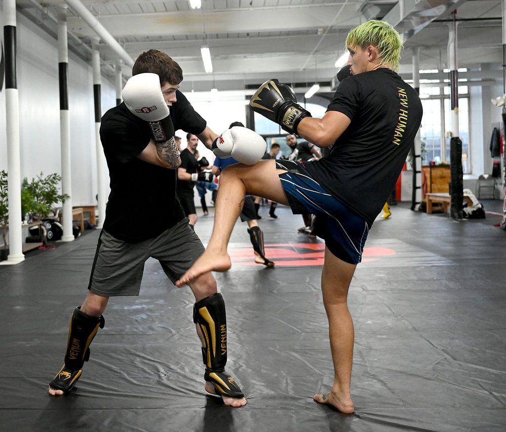 Mixed-martial arts fighter Kris Moutinho, 29, of Milford, right, spars with Brandon Demoura, 20, who is also from Milford,  at the Regiment Training Center in Fall River, August 5, 2021.  As a short-notice replacement, Moutinho competed in the Ultimate Fighting Championship 264 Fight of the Night on national television in Las Vegas, Nevada on July 10, and earned a $75,000 bonus check along the way.  The headlining clash was between Conor McGregor and Dustin Poirier.

5467081001p Mil Mma