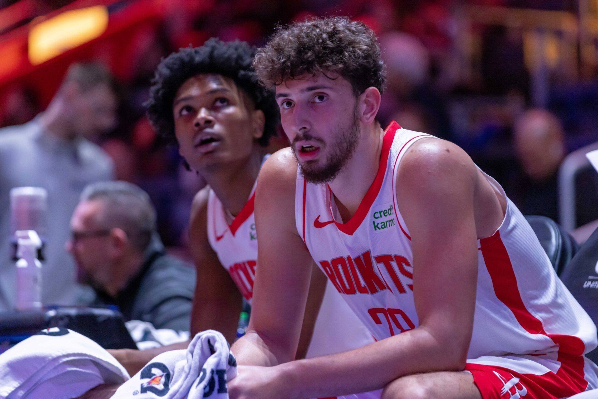 Houston Rockets center Alperen Sengun (28) and forward Amen Thompson (1) sit on the sidelines on a play stoppage against the Detroit Pistons during the in the first half at Little Caesars Arena.