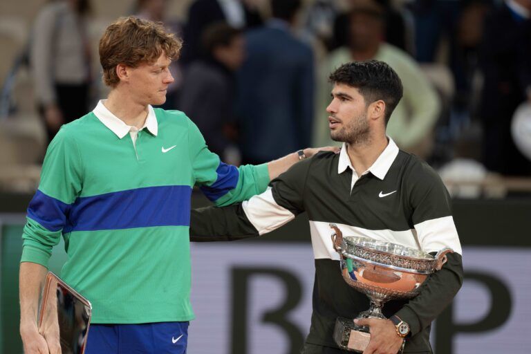 Jannik Sinner of Italy and Carlos Alcaraz of Spain pose together at the trophy presentation after the men’s singles final on day 15 at Roland Garros Stadium.