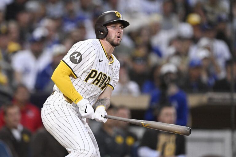 San Diego Padres center fielder Jackson Merrill (3) hits a RBI triple during the third inning against the Los Angeles Dodgers at Petco Park.