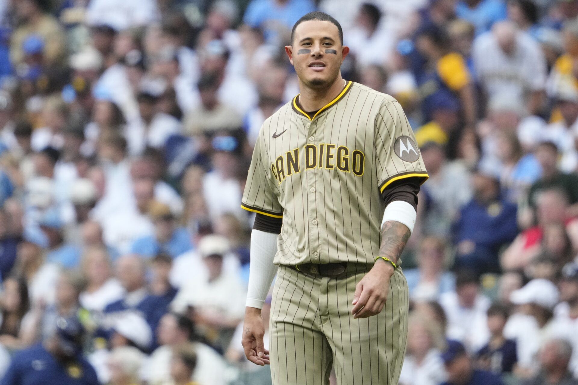 San Diego Padres third base Manny Machado (13) walks back to the dugout after getting called out at first base against the Milwaukee Brewers in the third inning at American Family Field.