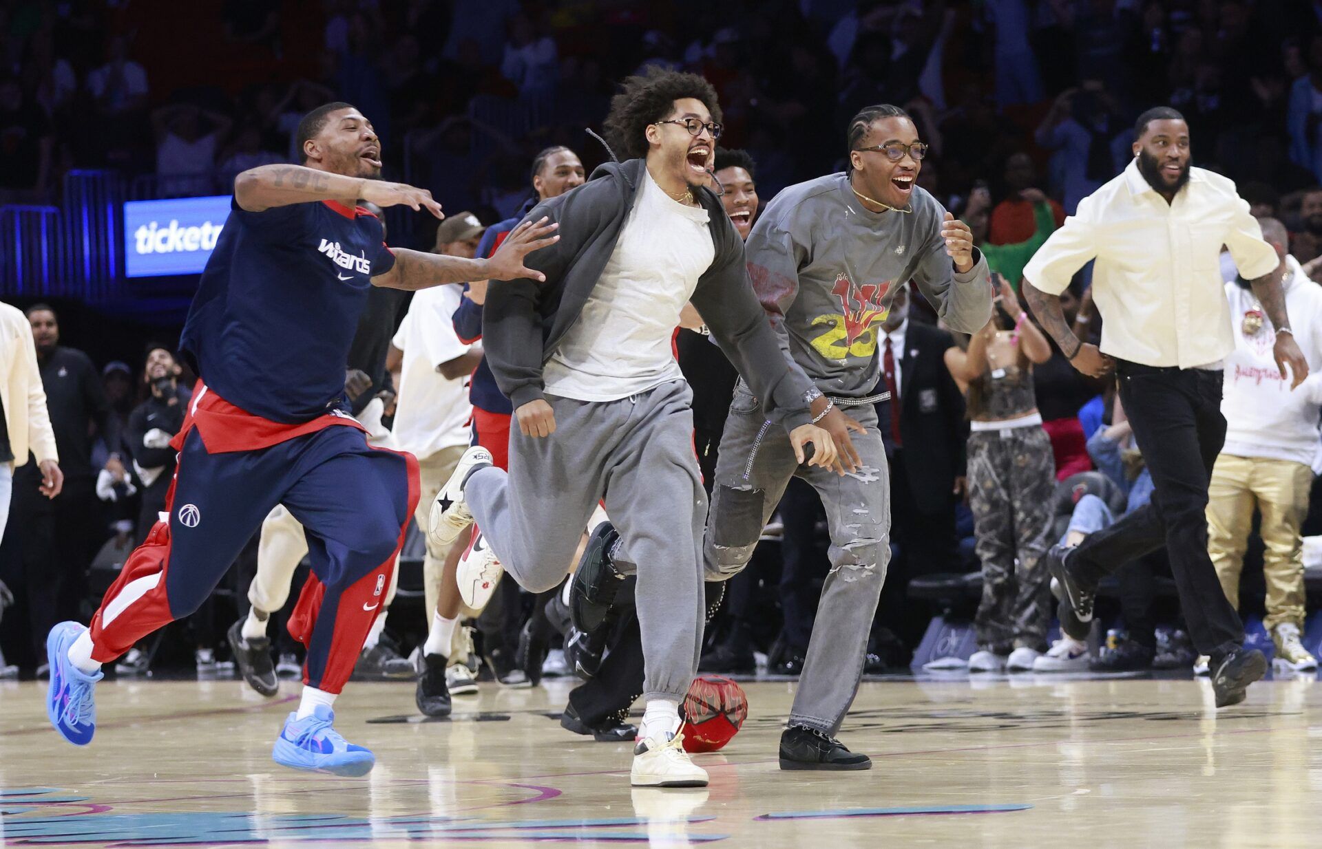 The Washington Wizards bench celebrates the Wizards win against the Miami Heat at Kaseya Center.