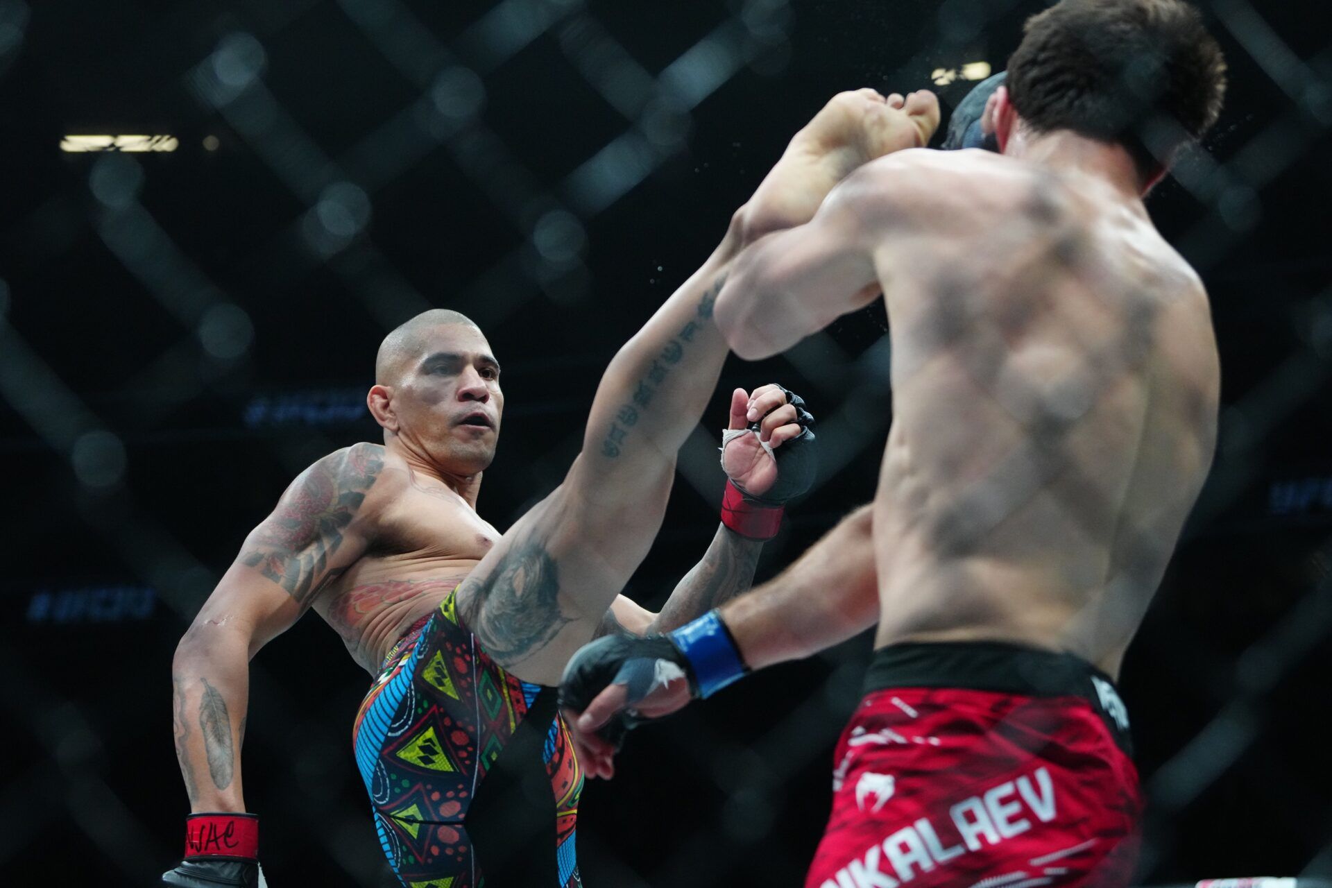Alex Pereira (red gloves) fights Magomed Ankalaev (blue gloves) during UFC 313 at T-Mobile Arena.