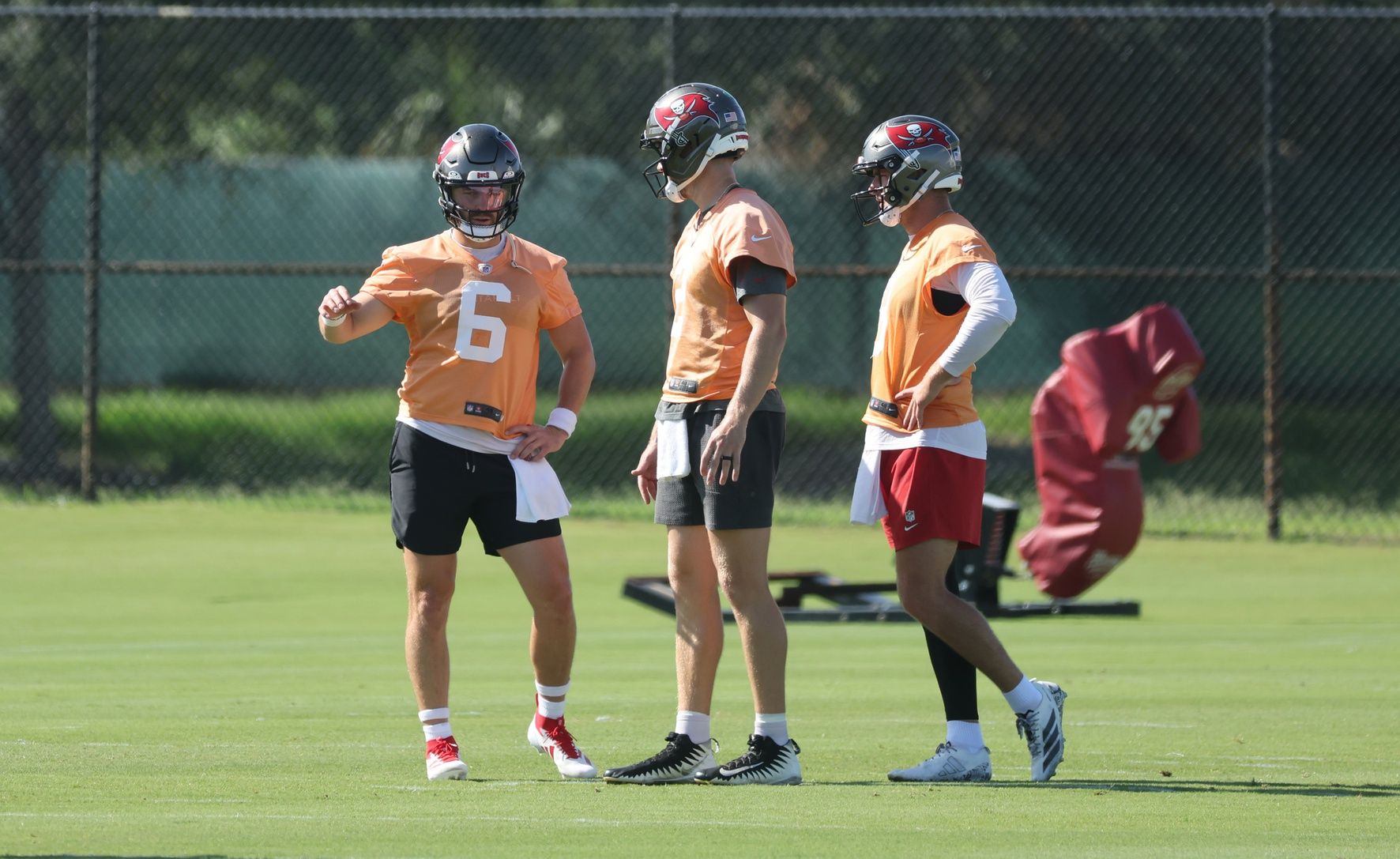 Tampa Bay Buccaneers quarterback Baker Mayfield (6), quarterback Kyle Trask (2) and quarterback Connor Bazelak (8) talk as they work out at One Buc Place.