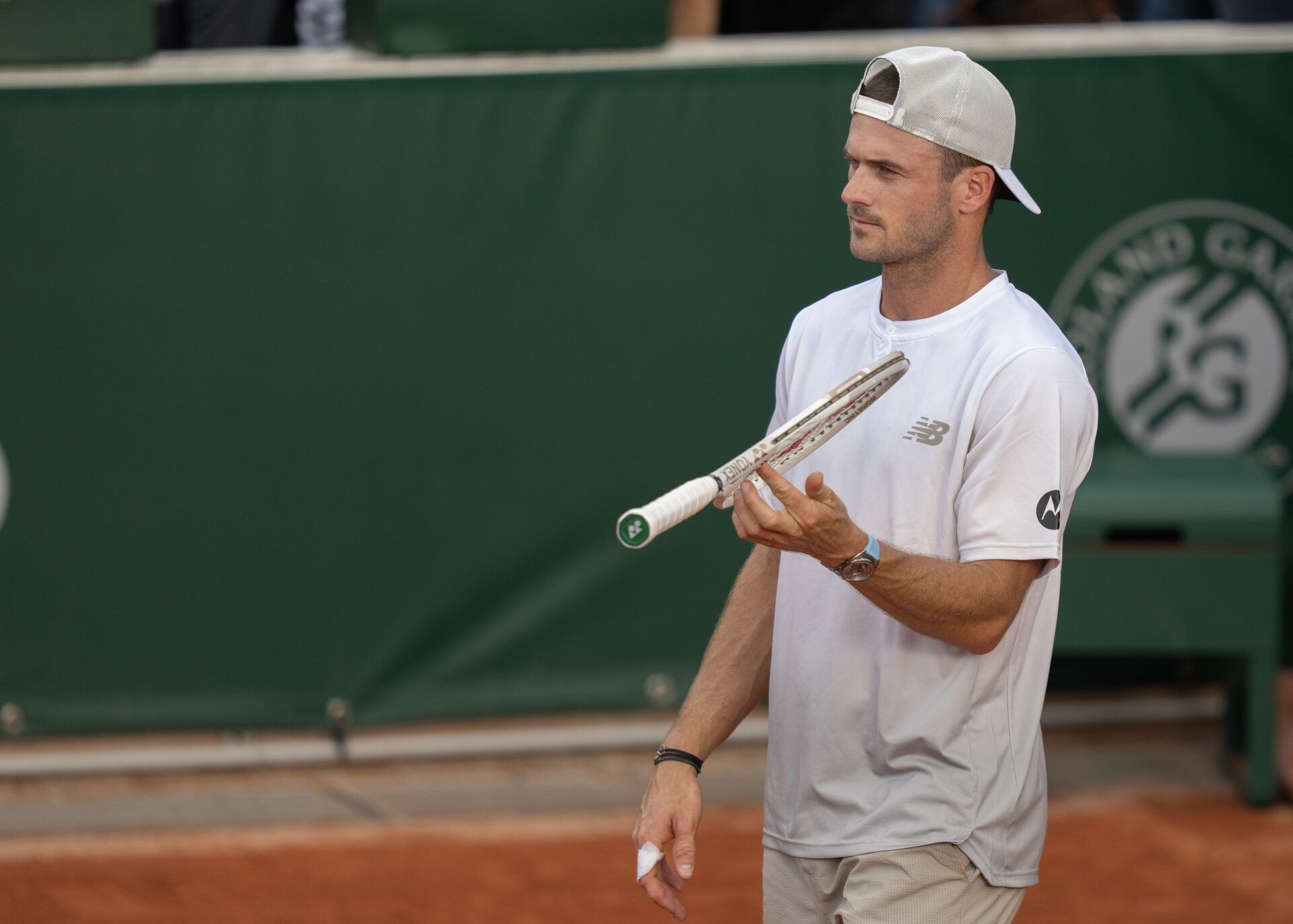 Tommy Paul of the United States spins his racket during his match against Marton Fucsovics of Hungary on day four at Roland Garros Stadium.