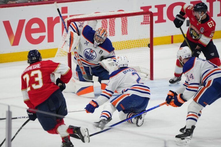 Florida Panthers forward Carter Verhaeghe (23) scores against Edmonton Oilers goaltender Stuart Skinner (74) and defenseman Evan Bouchard (2) during the first period in game three of the 2025 Stanley Cup Final at Amerant Bank Arena.