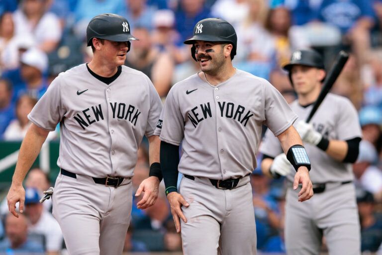 New York Yankees second base DJ LeMahieu (26) and New York Yankees catcher Austin Wells (28) celebrate after scoring during the second inning against the Kansas City Royals  at Kauffman Stadium.