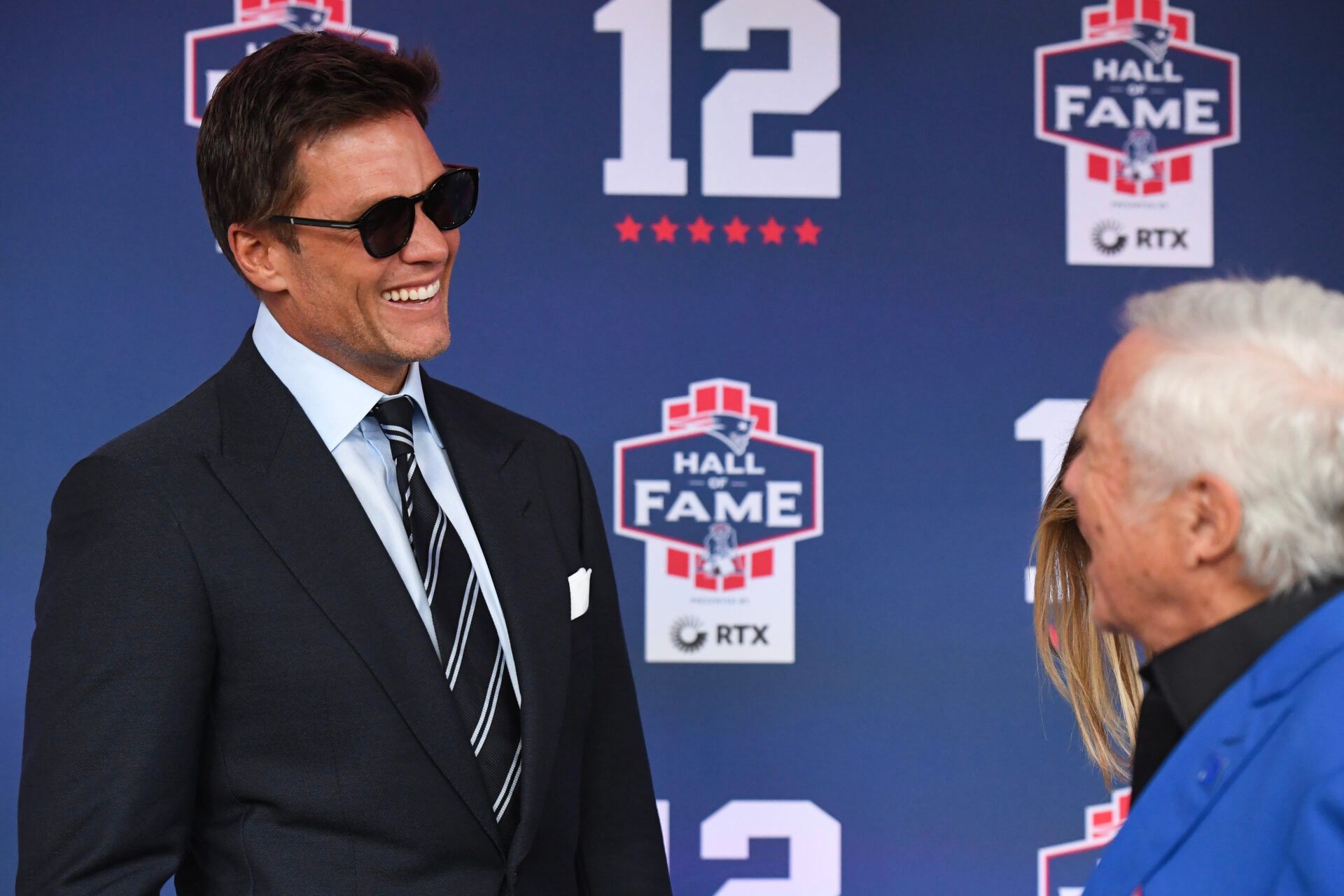 FOXBOROUGH, MASSACHUSETTS - JUNE 12: Tom Brady talks with New England Patriots CEO Robert Kraft during the 2024 Hall of Fame Induction Ceremony for Tom Brady at Gillette Stadium on June 12, 2024 in Foxborough, Massachusetts. (Photo by China Wong/Getty Images)