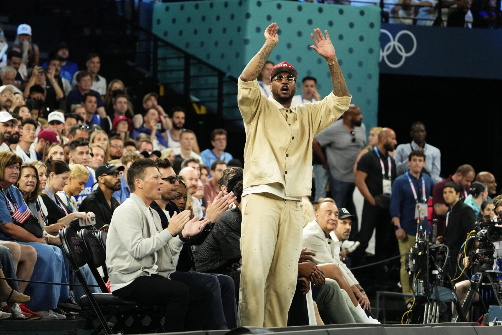 Carmelo Anthony cheers in the second half against France in the men's basketball gold medal game during the Paris 2024 Olympic Summer Games at Accor Arena.