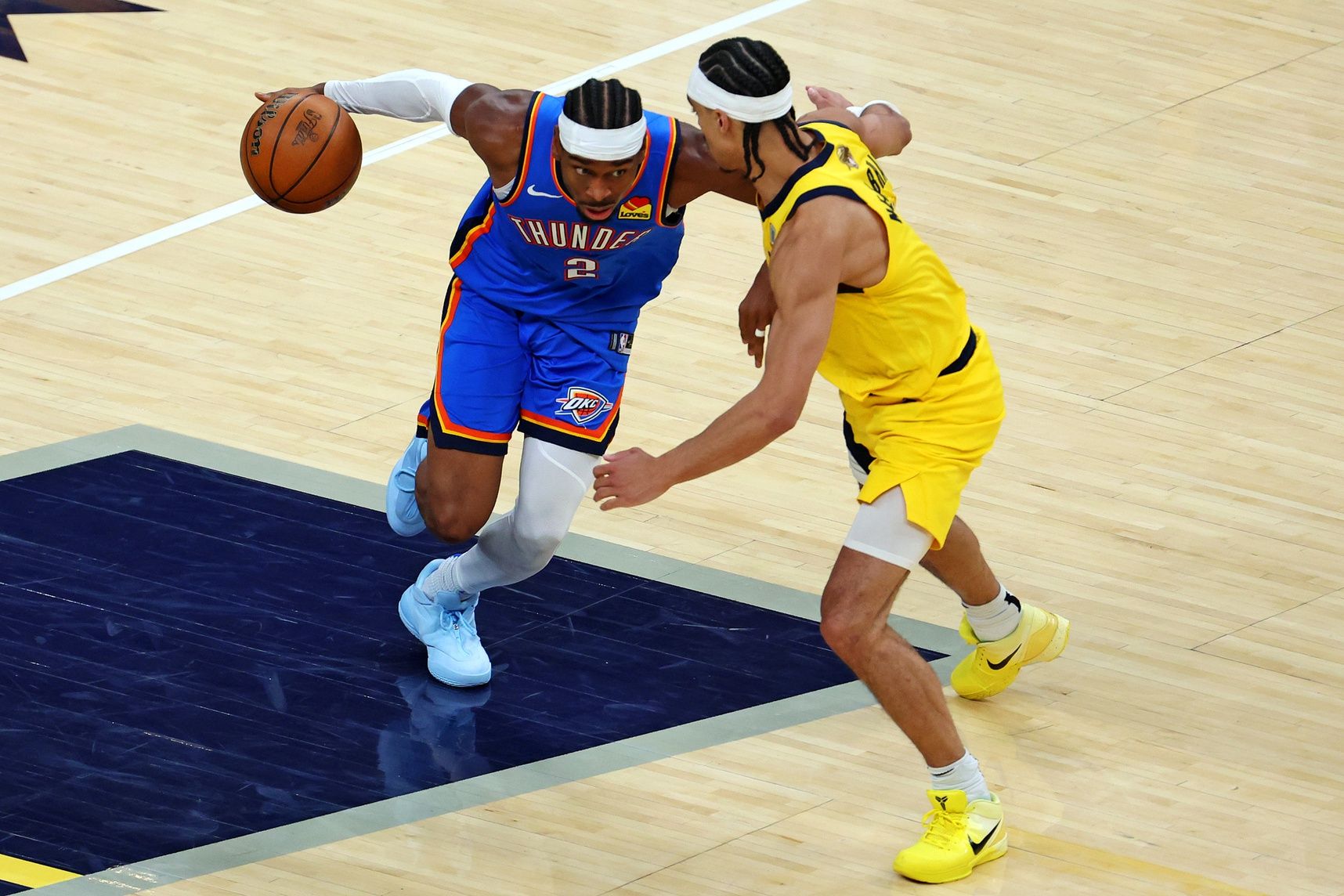 Oklahoma City Thunder guard Shai Gilgeous-Alexander (2) drives to the basket against Indiana Pacers guard Andrew Nembhard (2) during the fourth quarter in game three of the 2025 NBA Finals at Gainbridge Fieldhouse.