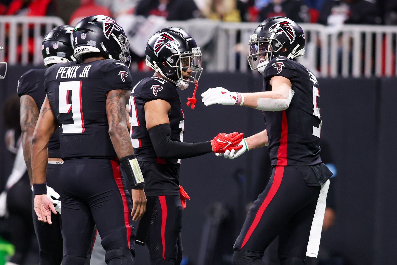 Atlanta Falcons wide receiver Drake London (5) celebrates after a touchdown catch with teammates against the Carolina Panthers in the fourth quarter at Mercedes-Benz Stadium.