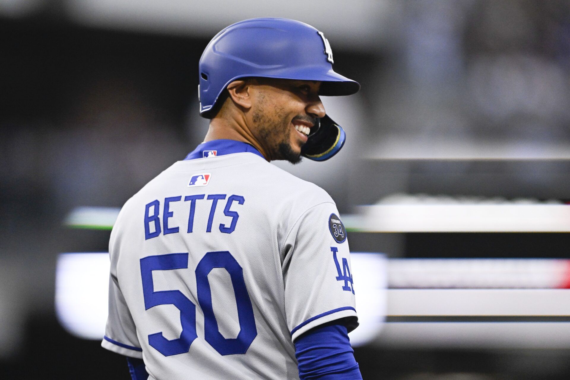 Los Angeles Dodgers shortstop Mookie Betts (50) smiles after walking during the third inning against the San Diego Padres at Petco Park.