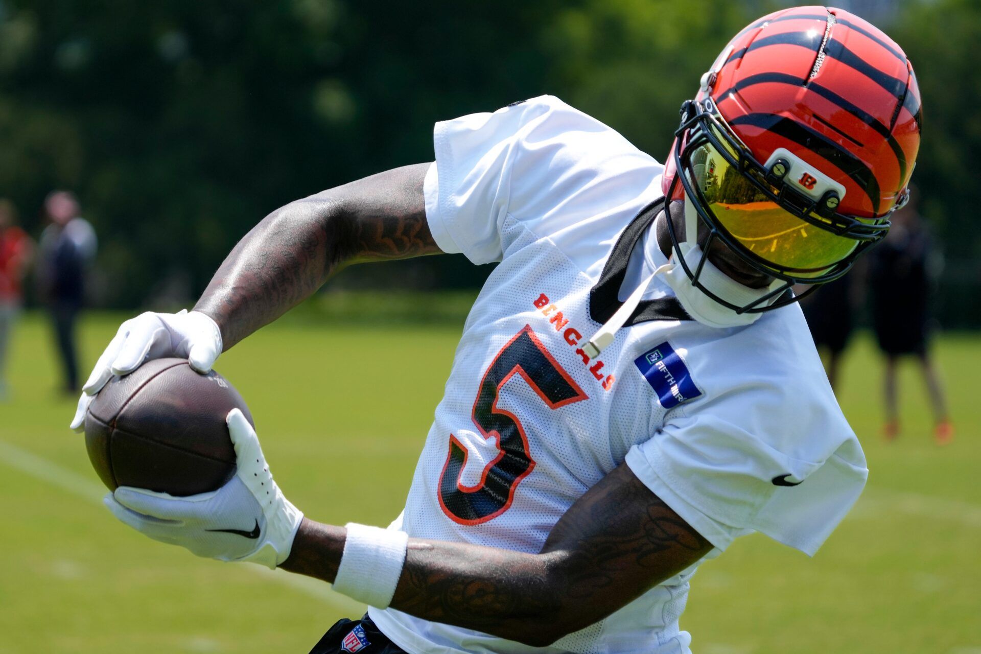 Cincinnati Bengals wide receiver Tee Higgins (5) catches a pass during a session of organized team activities on the Bengals practice field at Paycor Stadium in downtown Cincinnati on Tuesday, June 3, 2025.