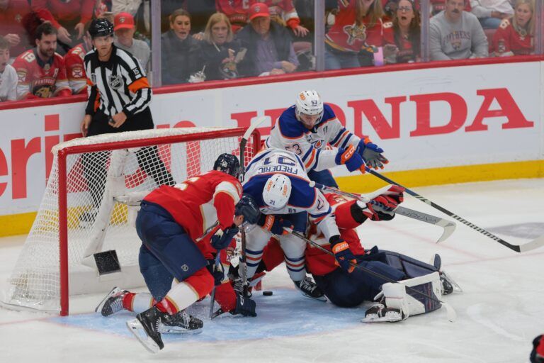 Florida Panthers goaltender Sergei Bobrovsky (72) defends against Edmonton Oilers center Trent Frederic (21) and center Jeff Skinner (53) during overtime in game four of the 2025 Stanley Cup Final at Amerant Bank Arena.