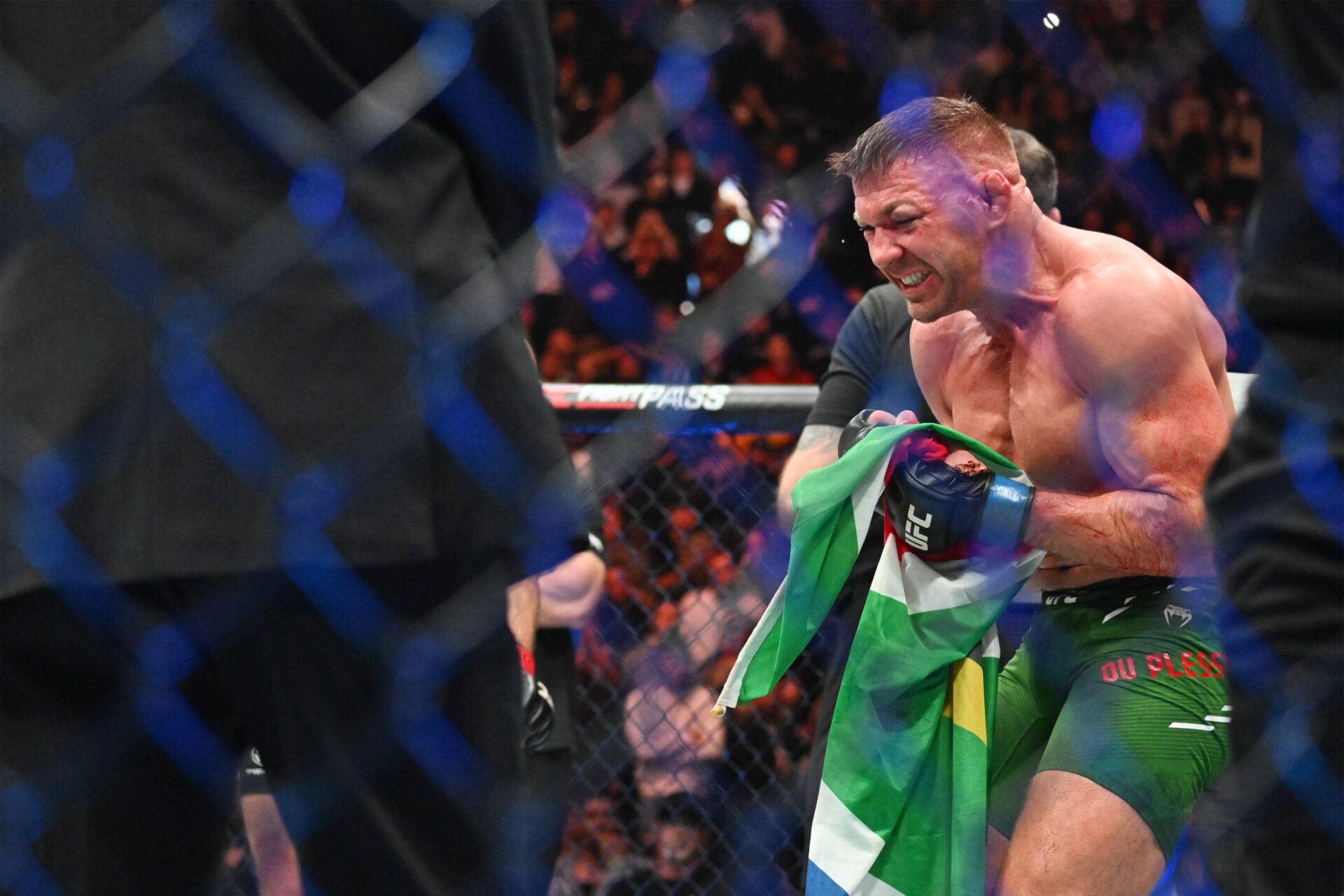 Dricus Du Plessis (blue gloves) celebrates defeating Sean Strickland (red glove) during UFC 297 at ScotiaBank Arena.