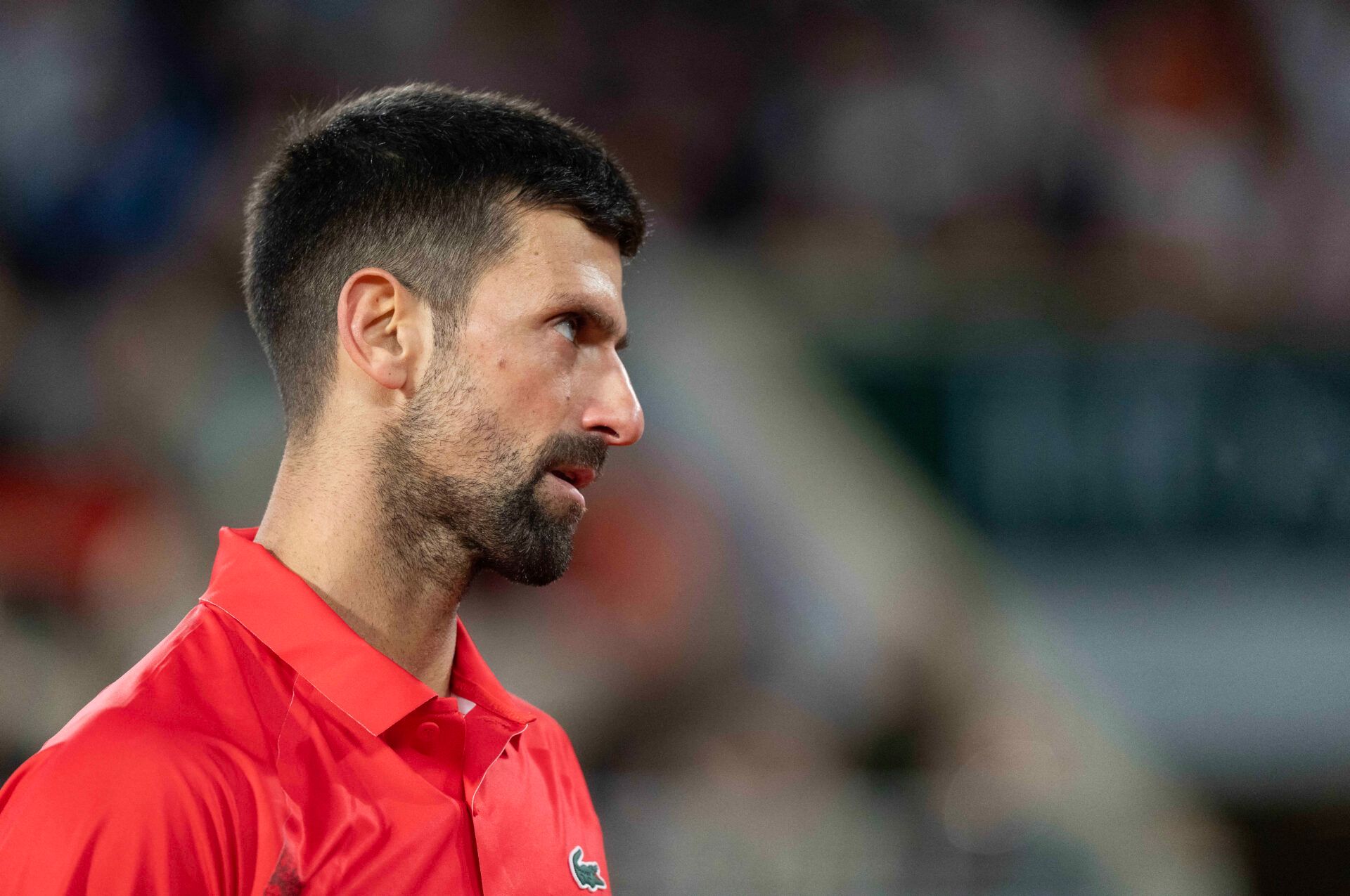 Novak Djokovic of Serbia reacts to a point during his match against Jannik Sinner of Italy on day 13 at Roland Garros Stadium.