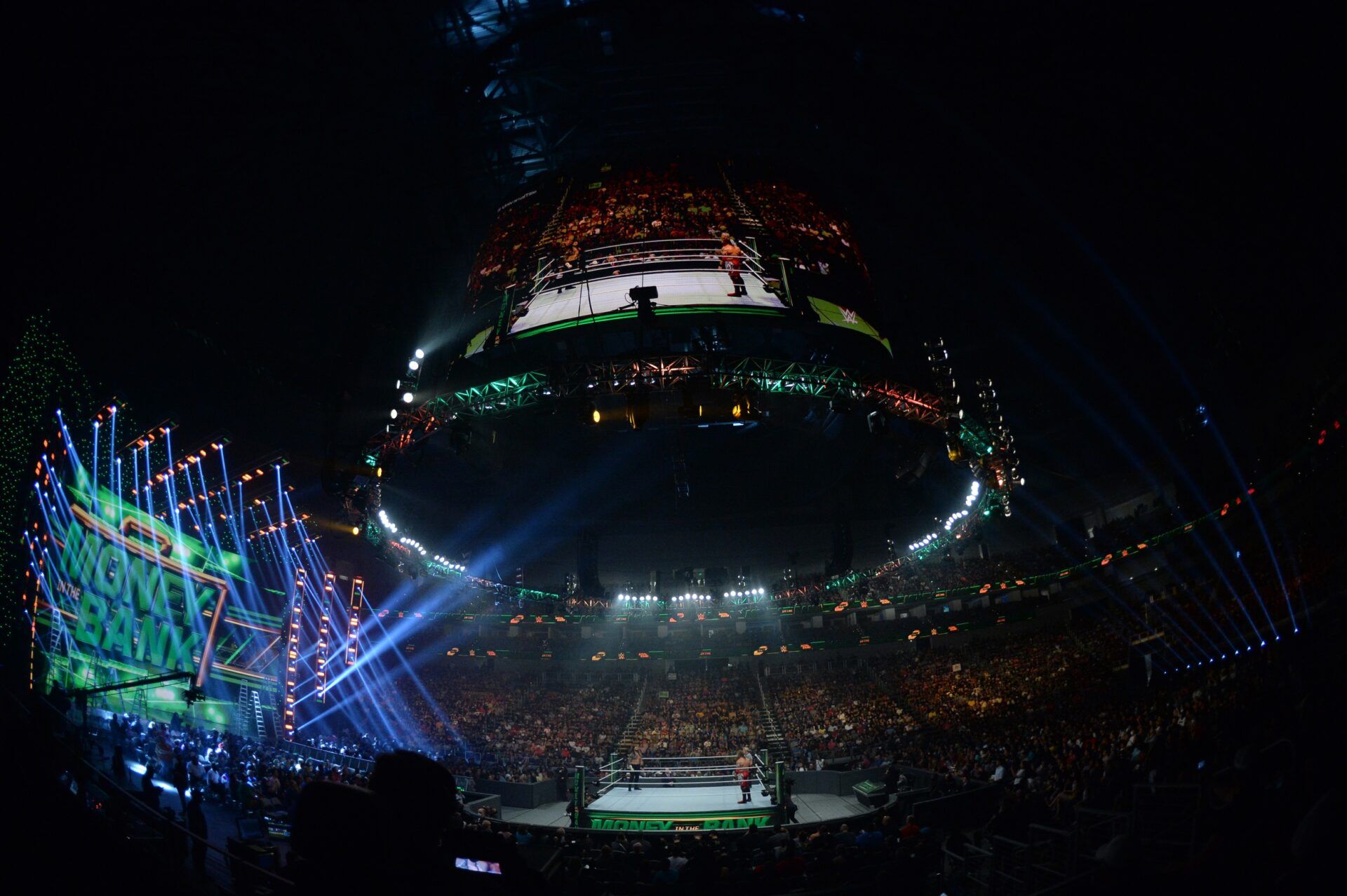 Roman Reigns (black pants) with Paul Heyman (suit) and Edge (red pants) battle for the WWE Universal Championship during Money in the Bank at Dickies Arena.