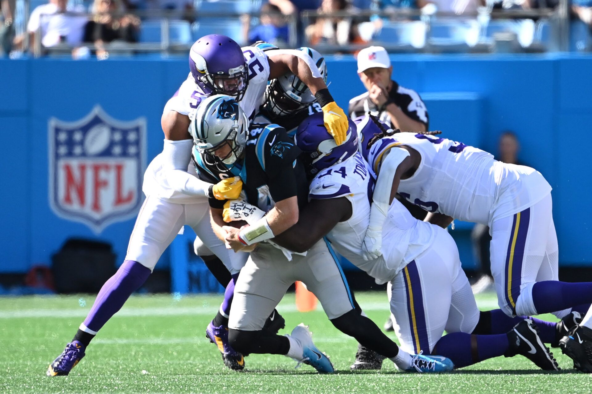 Carolina Panthers quarterback Sam Darnold (14) is tackled by Minnesota Vikings outside linebacker Anthony Barr (55) and defensive tackles Dalvin Tomlinson (94) and Armon Watts (96) in the second half at Bank of America Stadium.